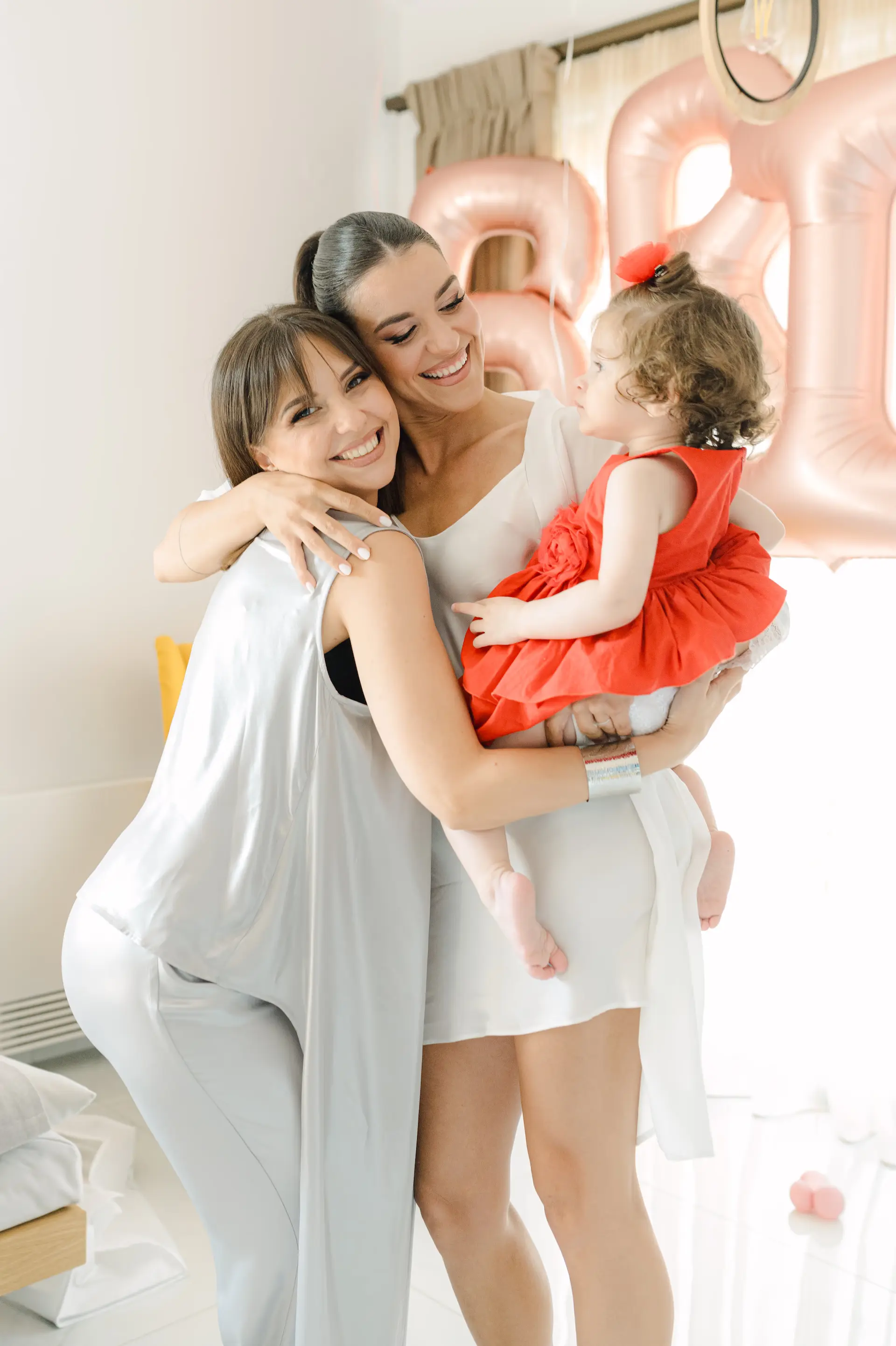 a group of women holding a baby