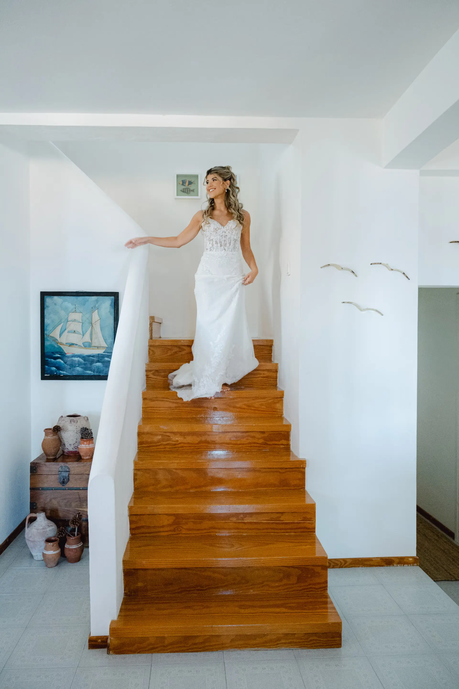 Candid moment of the bride coming down the stairs for her grand entrance