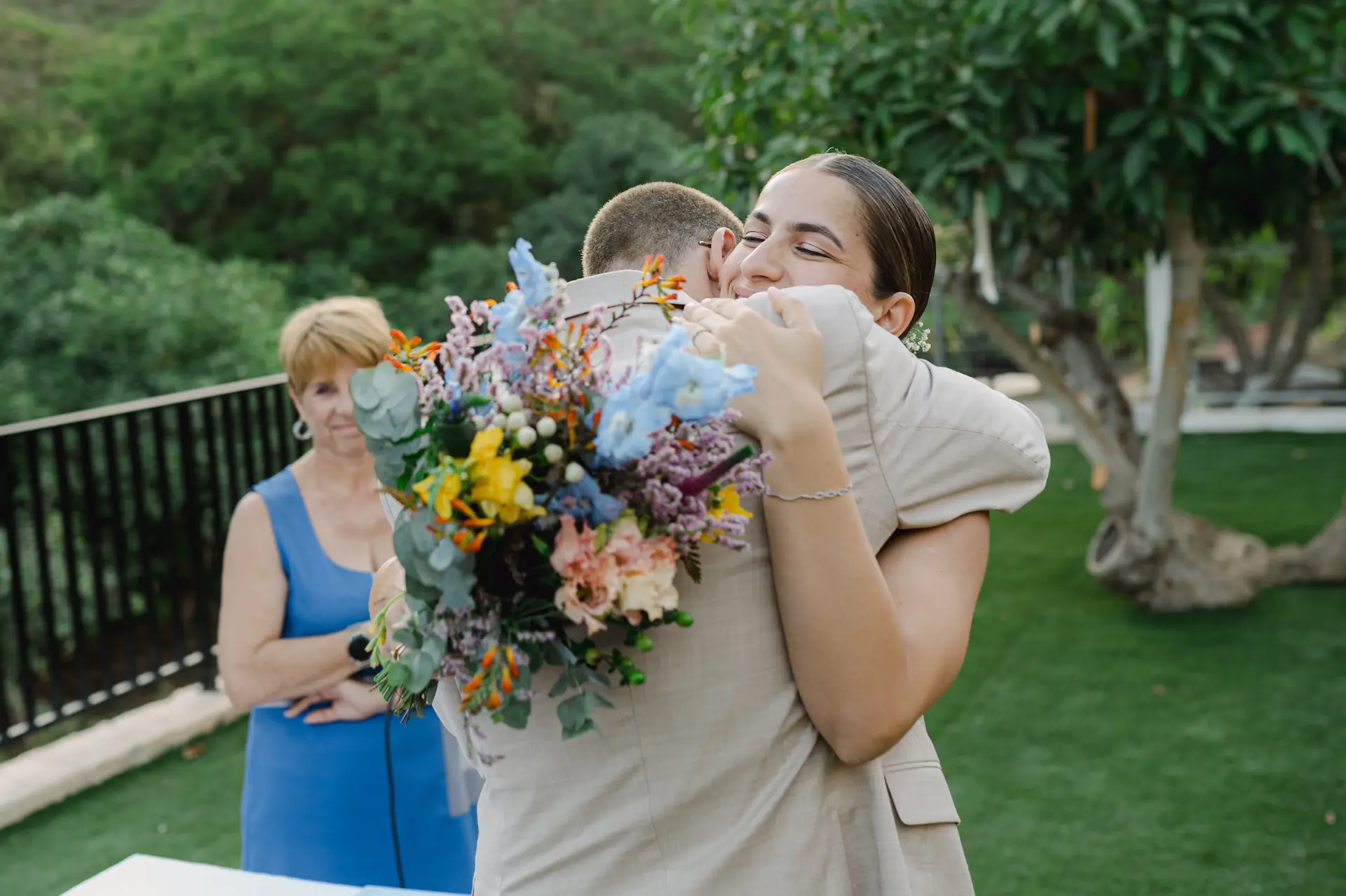 groom emotionally hugging bride during wedding ceremony