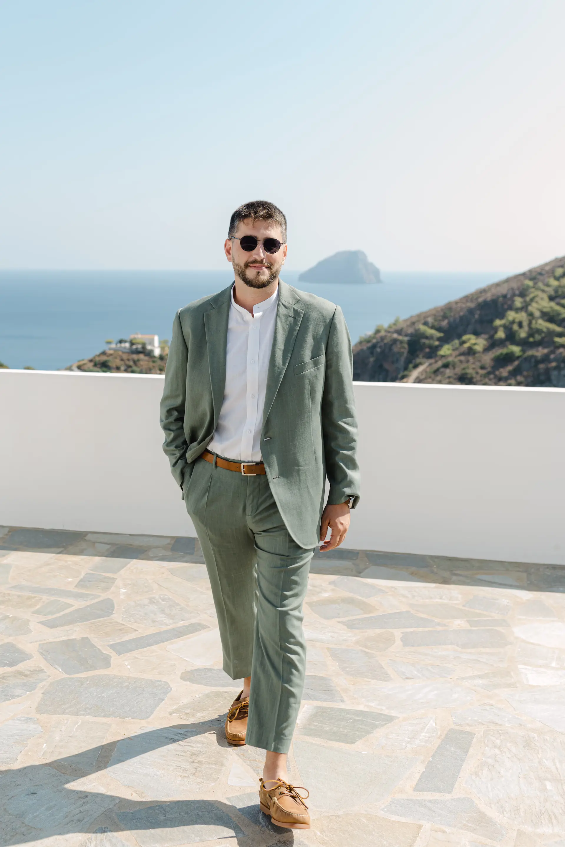 Groom's portrait with a stunning Aegean Sea view in Kythira, Greek island destination wedding.