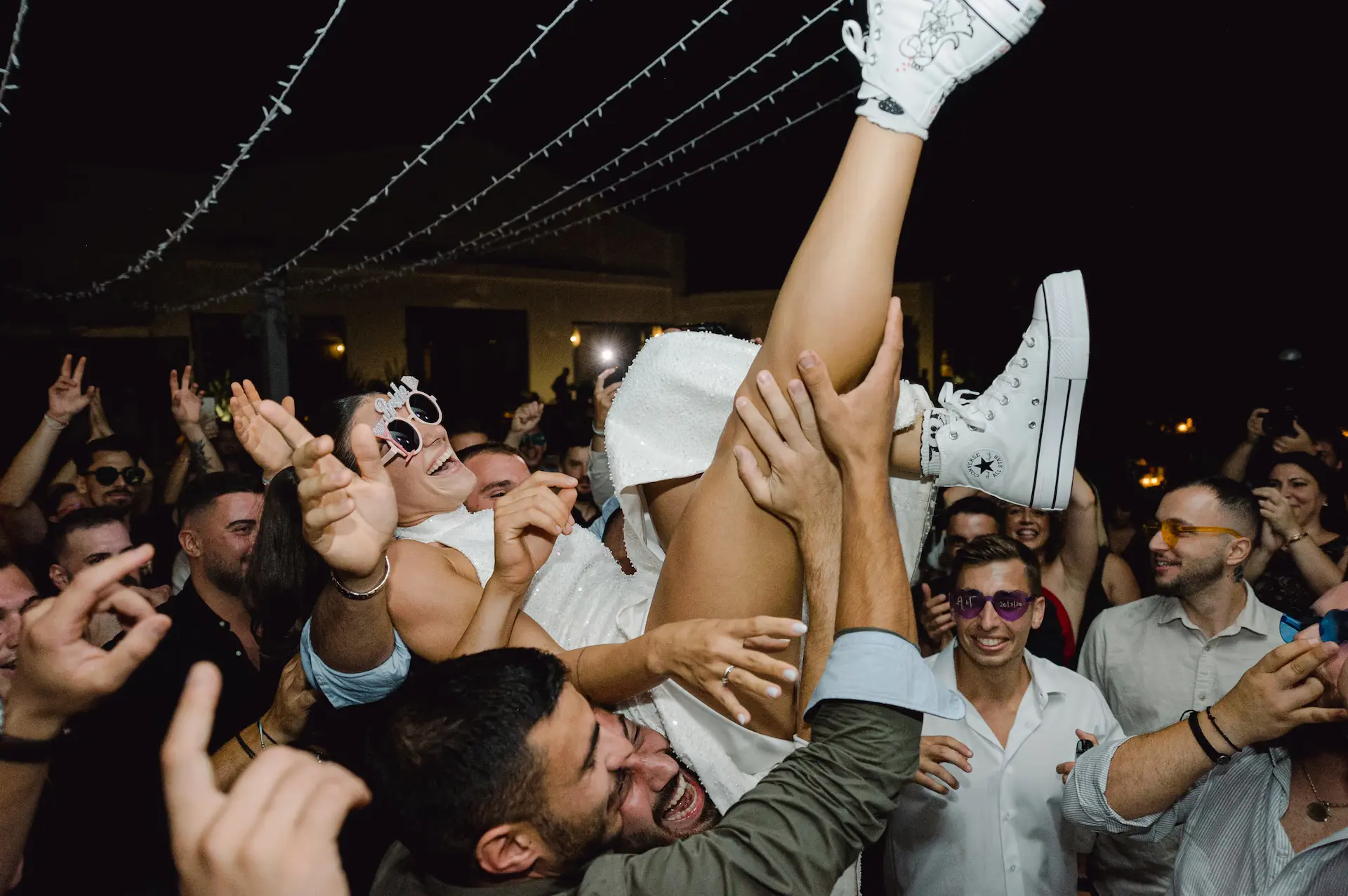 a group of people holding up a woman