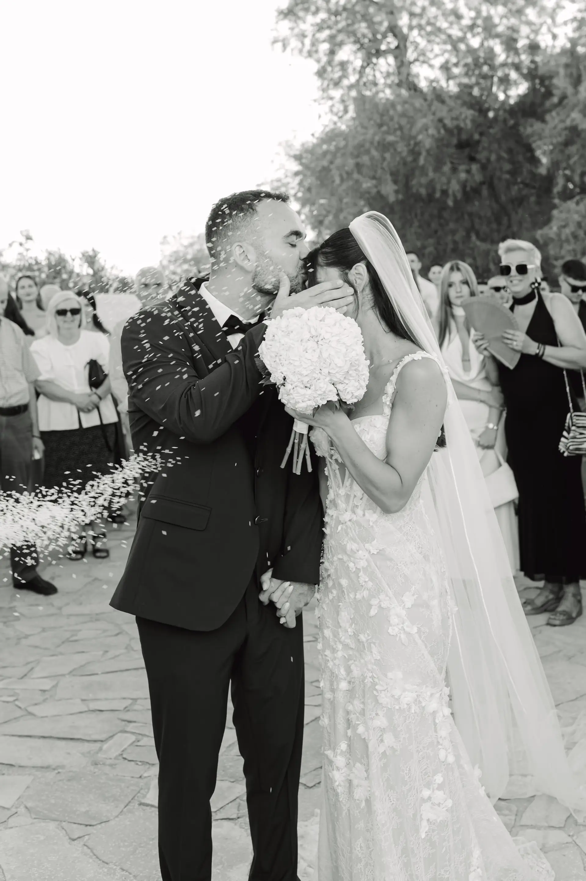 romantic photo in black and white of groom kissing the bride