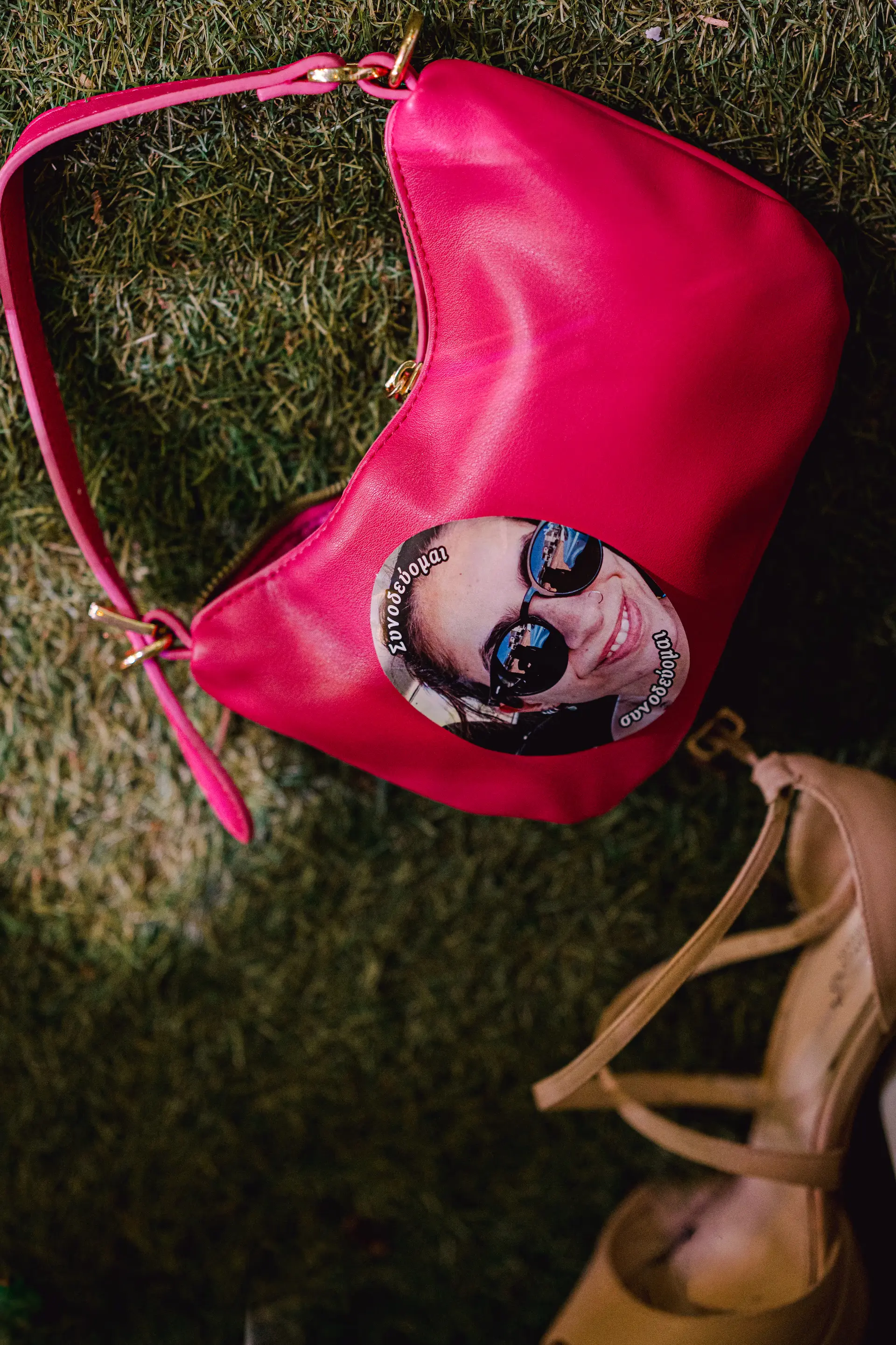 a pink purse with bride's face sticker on it