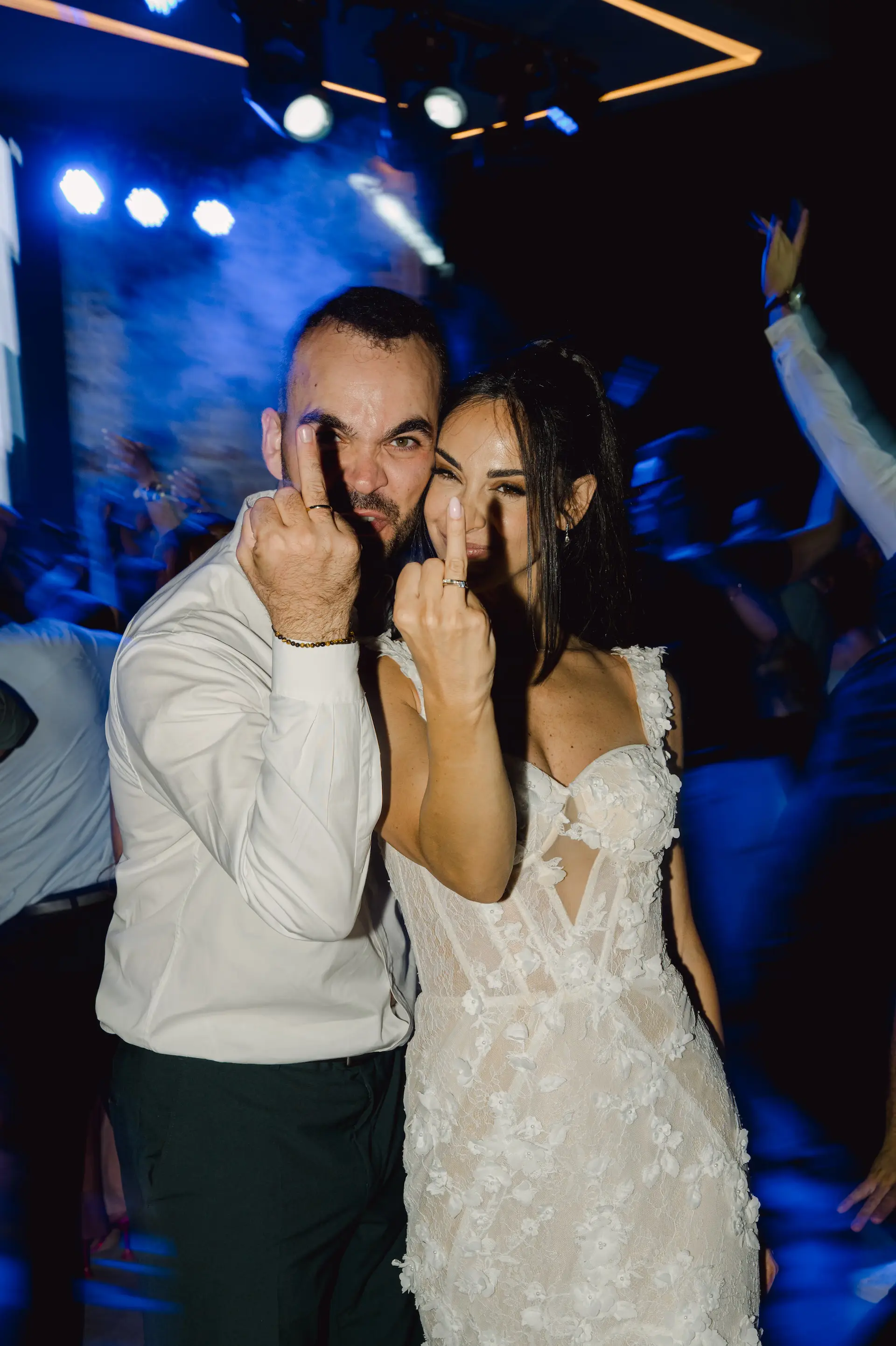 bride and groom posing for a funny photo during their party