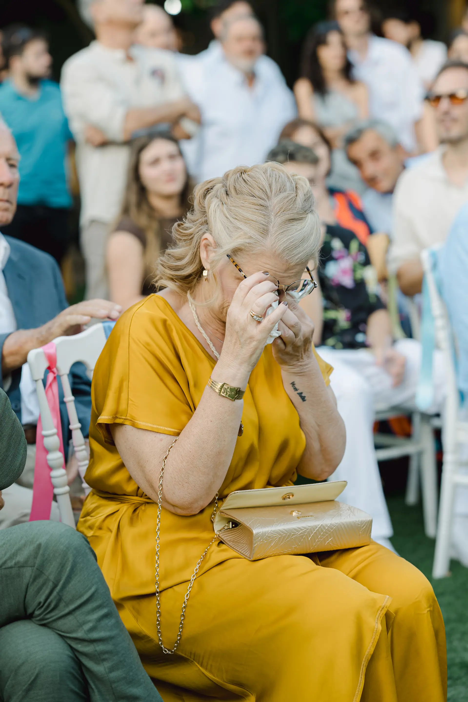 bride's mother crying in a crowd