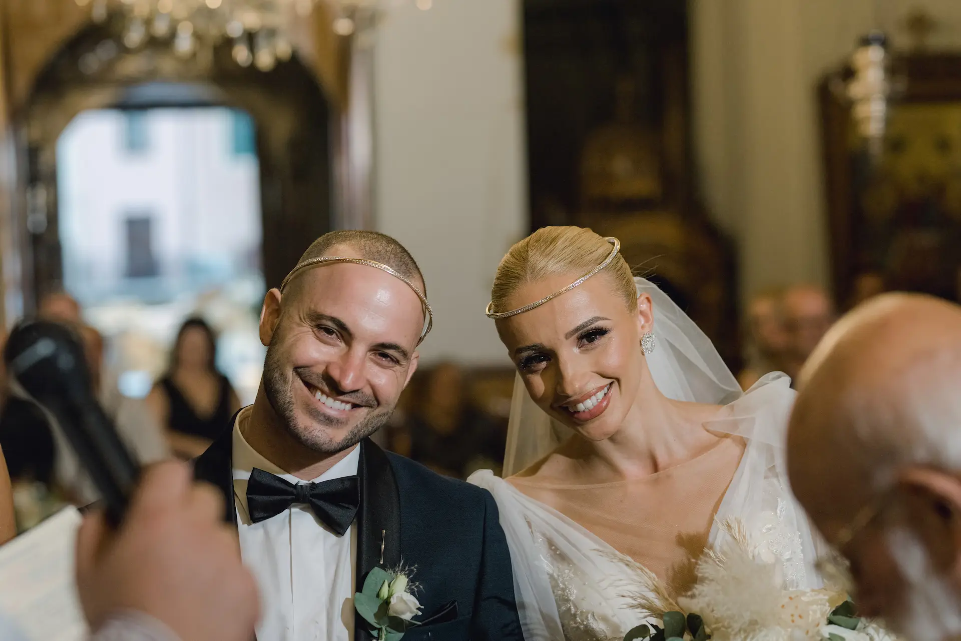 bride and groom smiling at the camera during wedding ceremony
