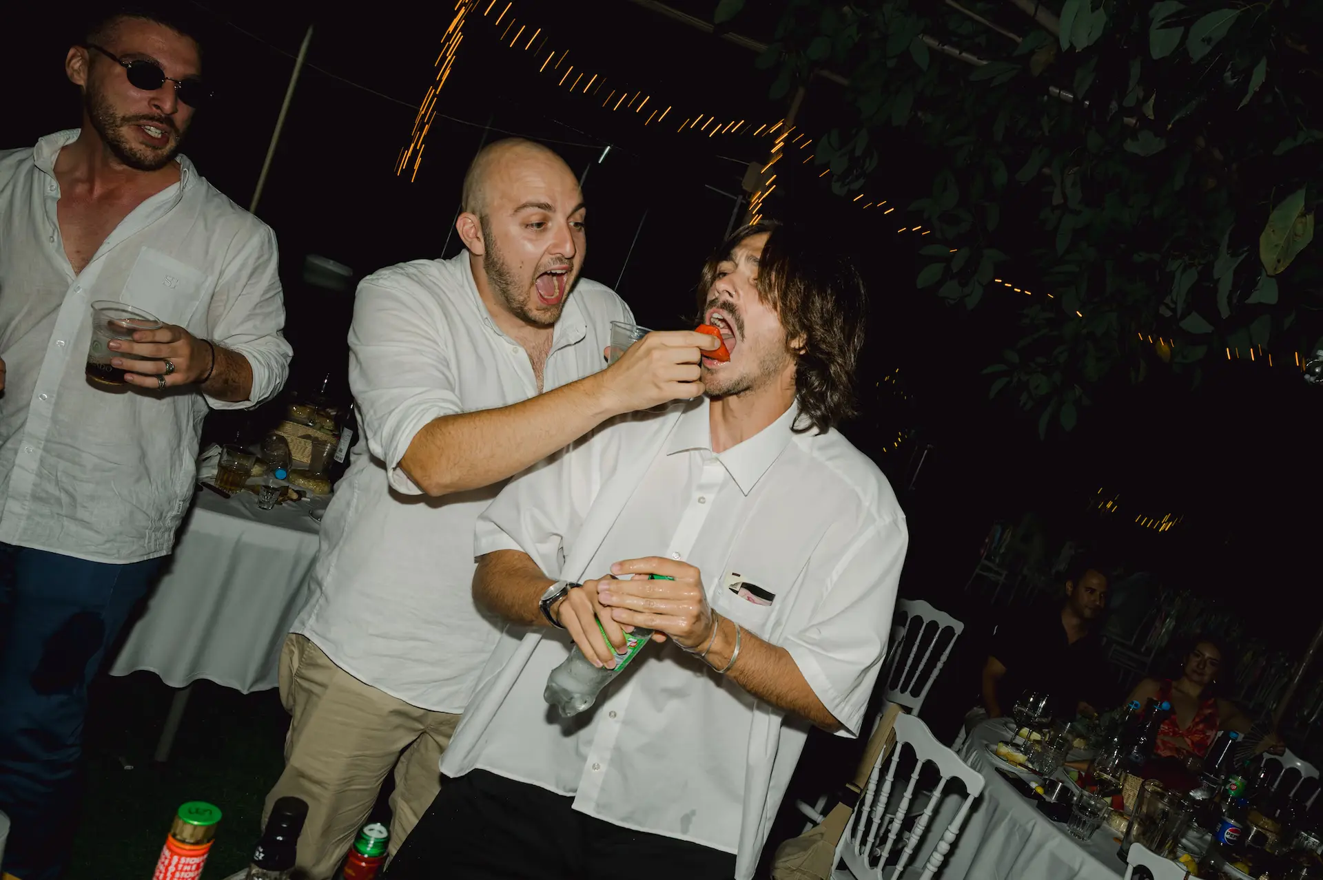 funny moment of guests feeding watermelon