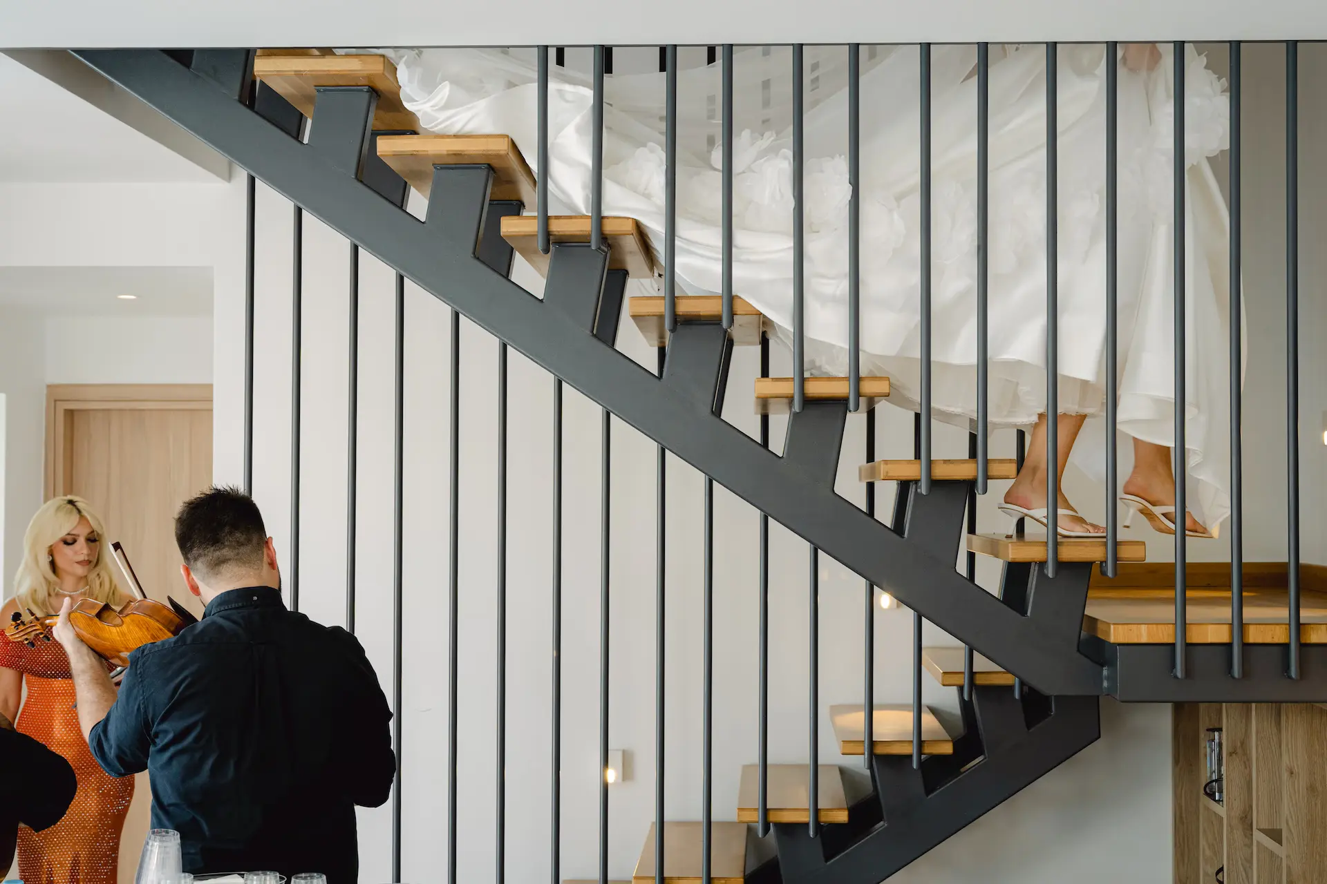 artistic photo of bride coming down with stairs 
