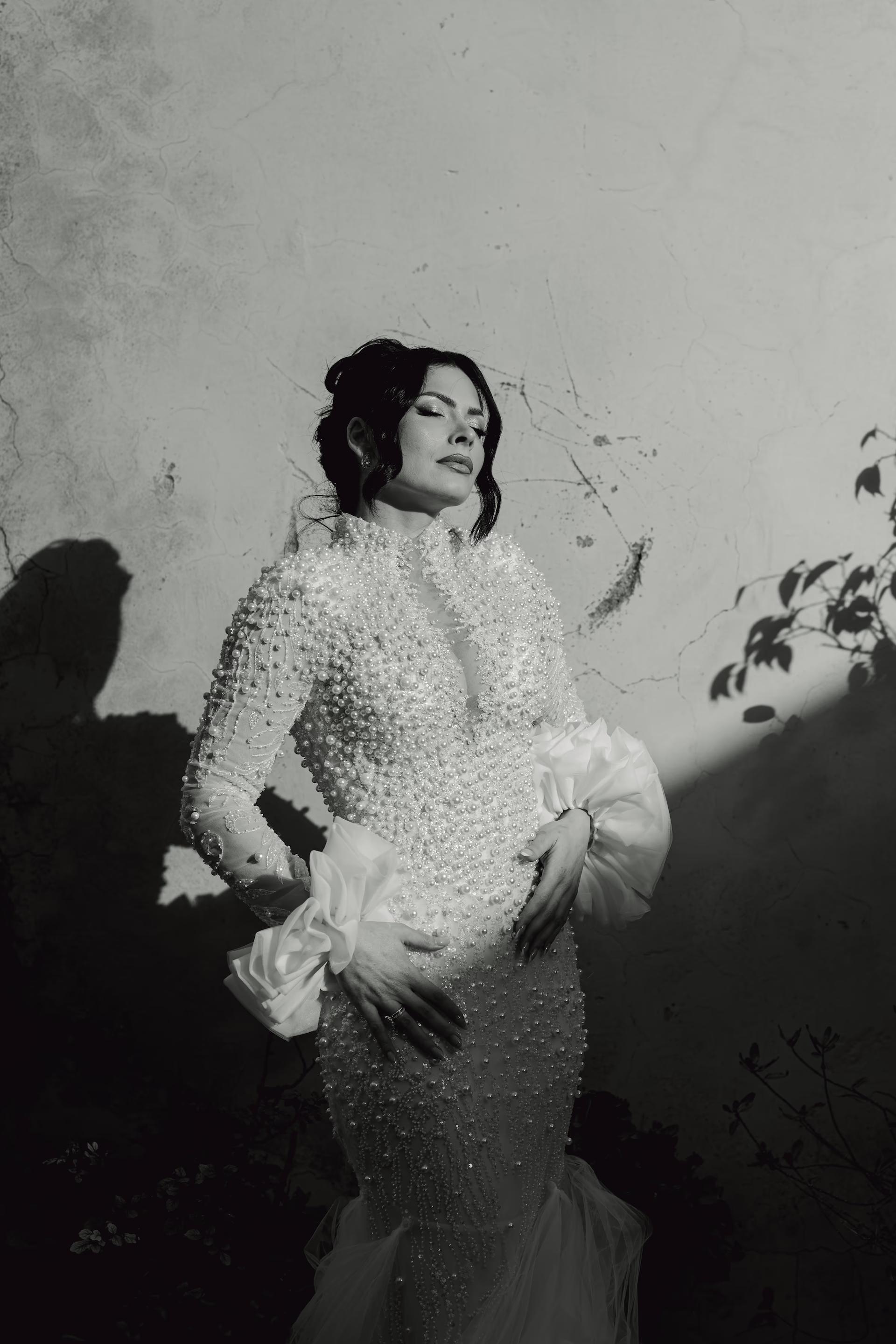 Editorial black and white portrait of bride in sunlight