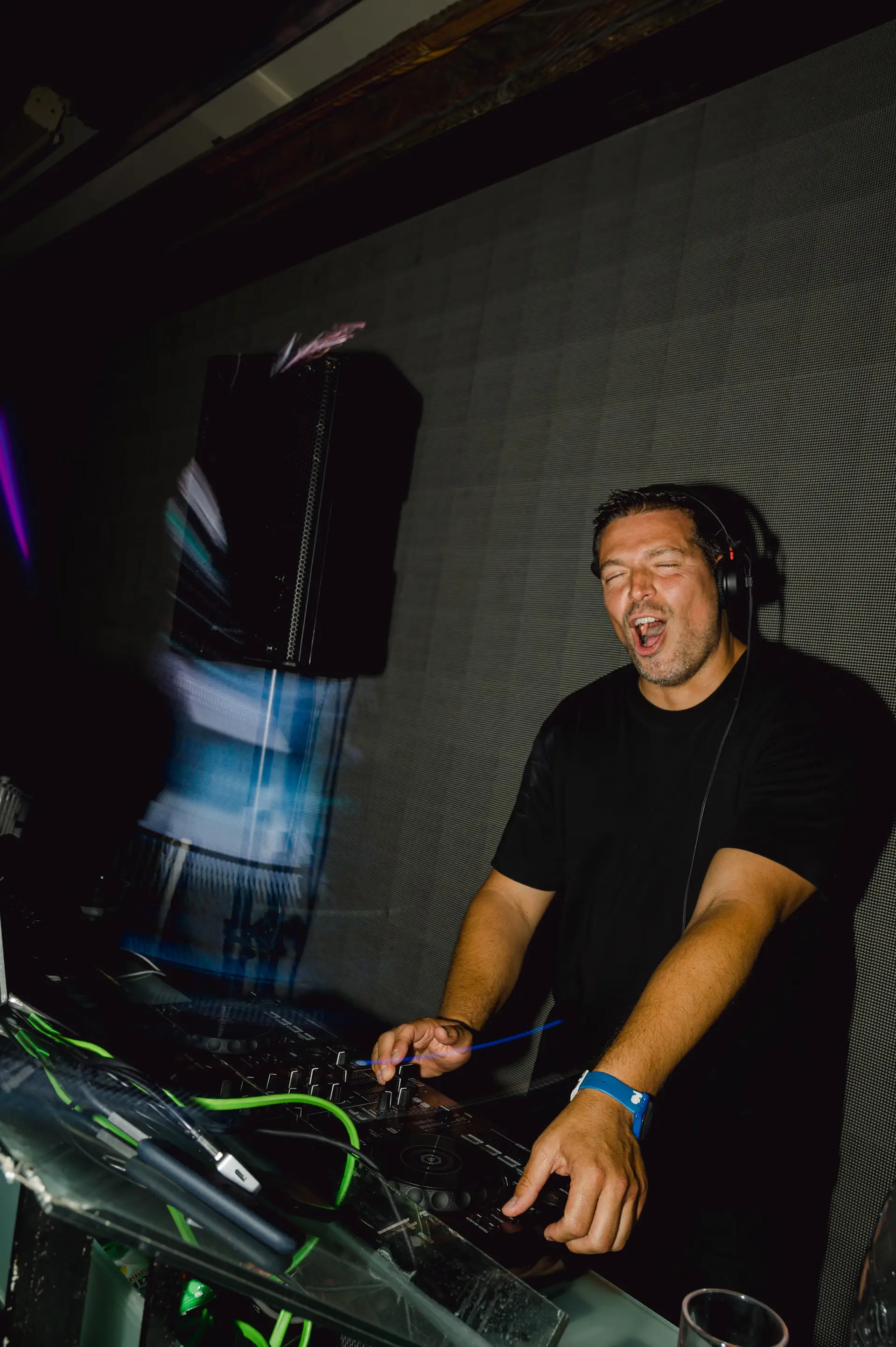 Dj Aristotle Manoudakis dancing while playing music