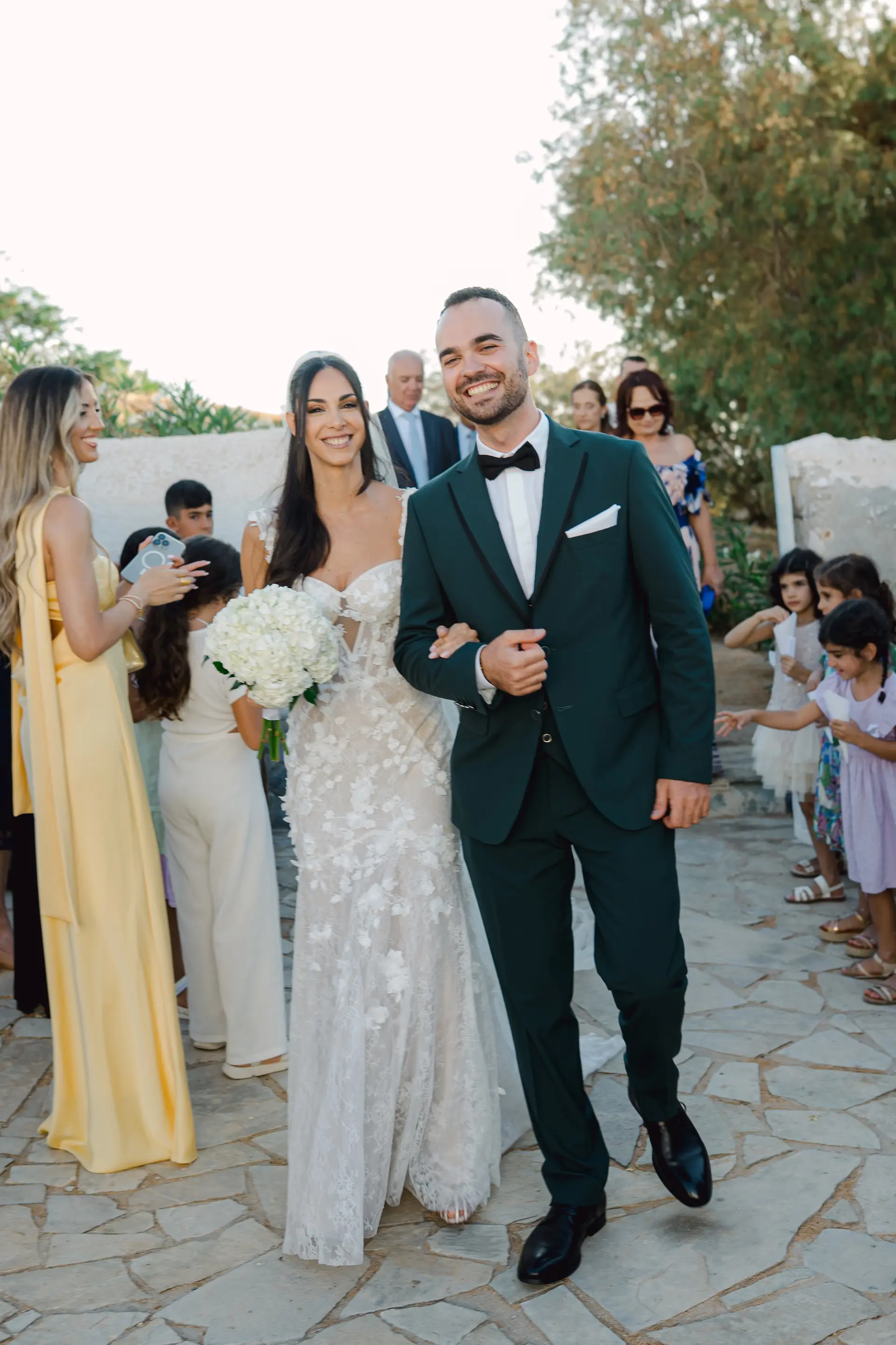 Candid shot of the newlyweds walking down a stone path, capturing a simple and authentic moment.