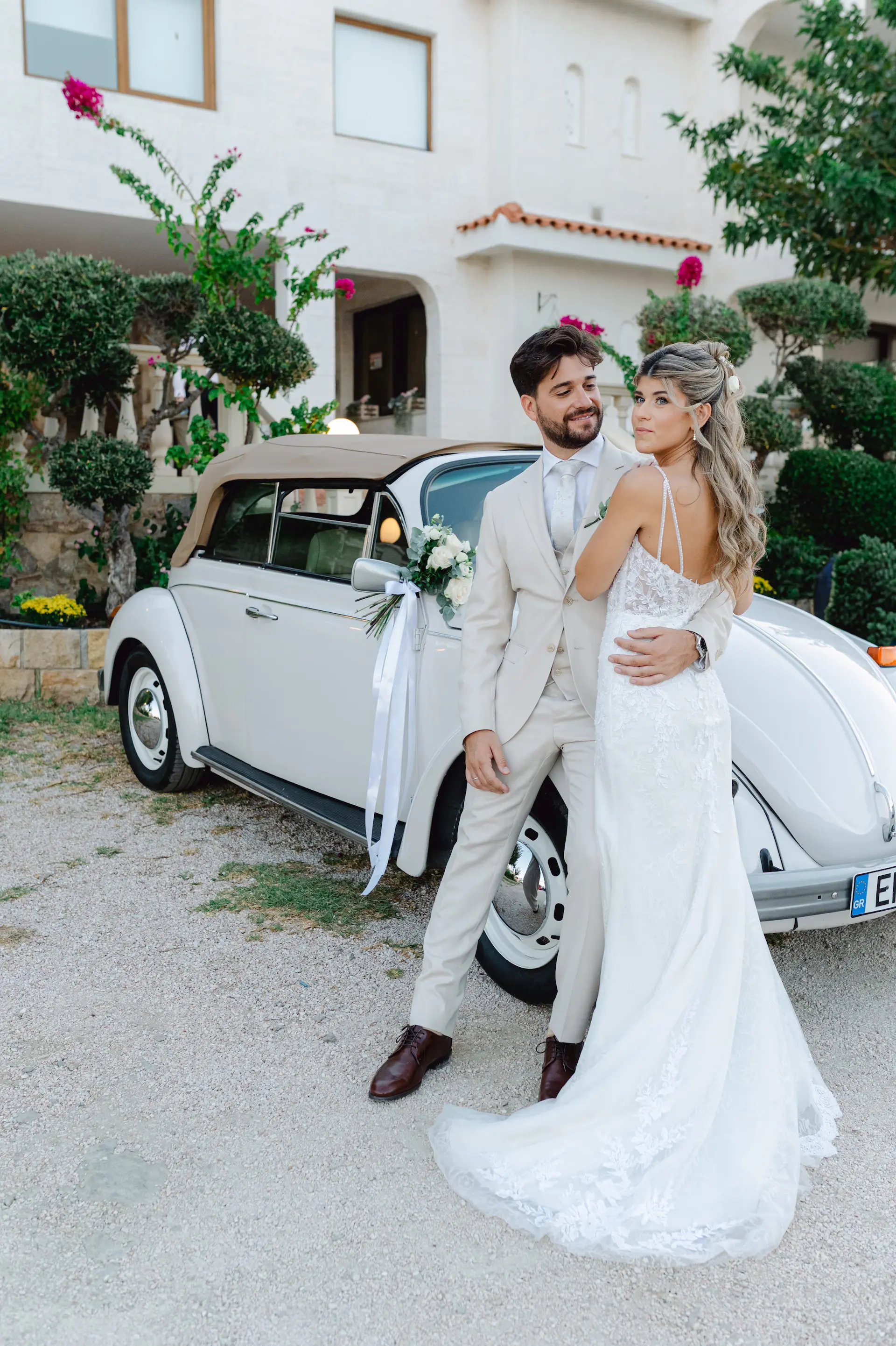 Elegant wedding photoshoot of a bride and groom with a classic vintage car
