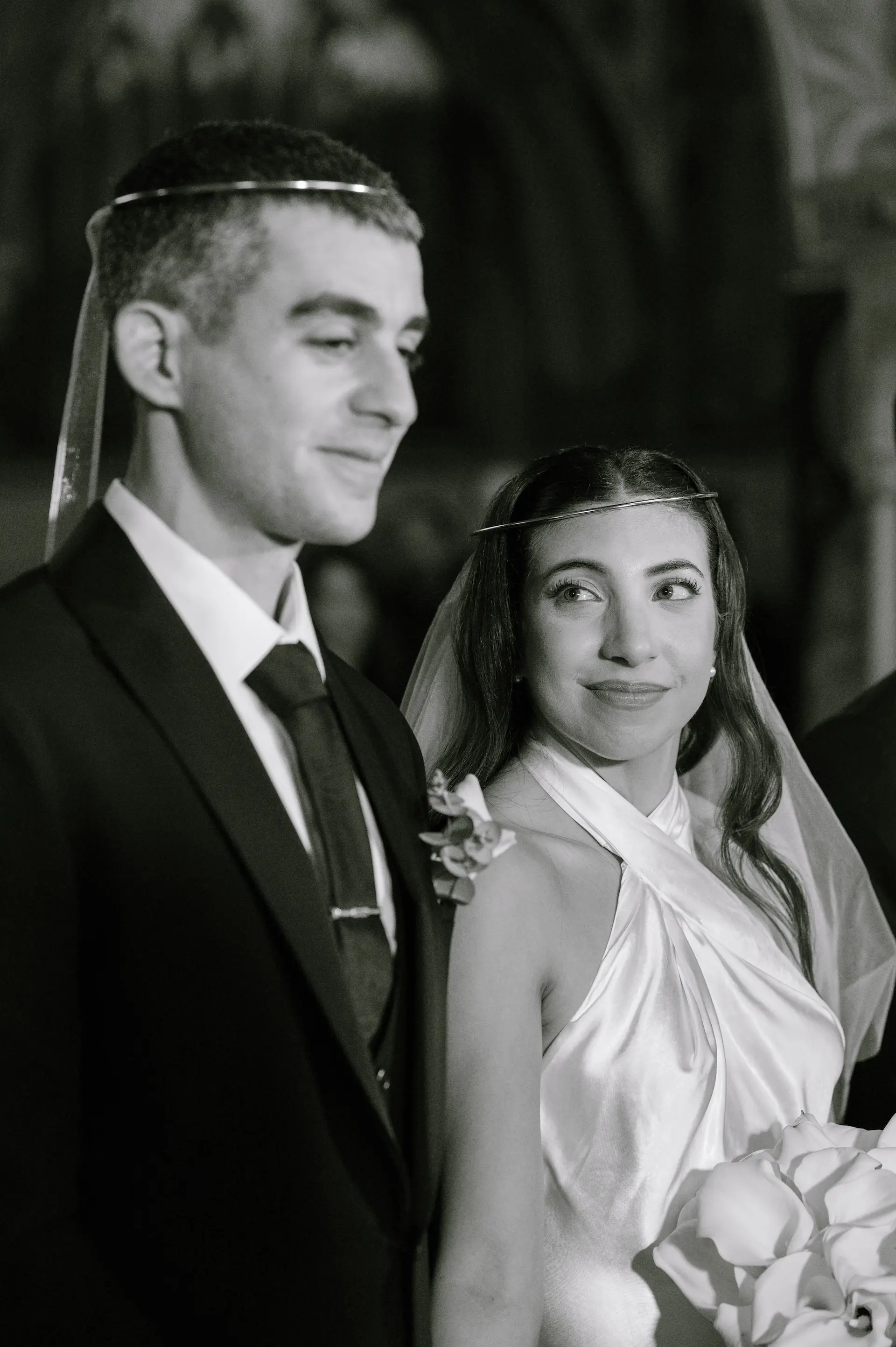 Close-up of the bride looking emotionally at the groom during the wedding ceremony.