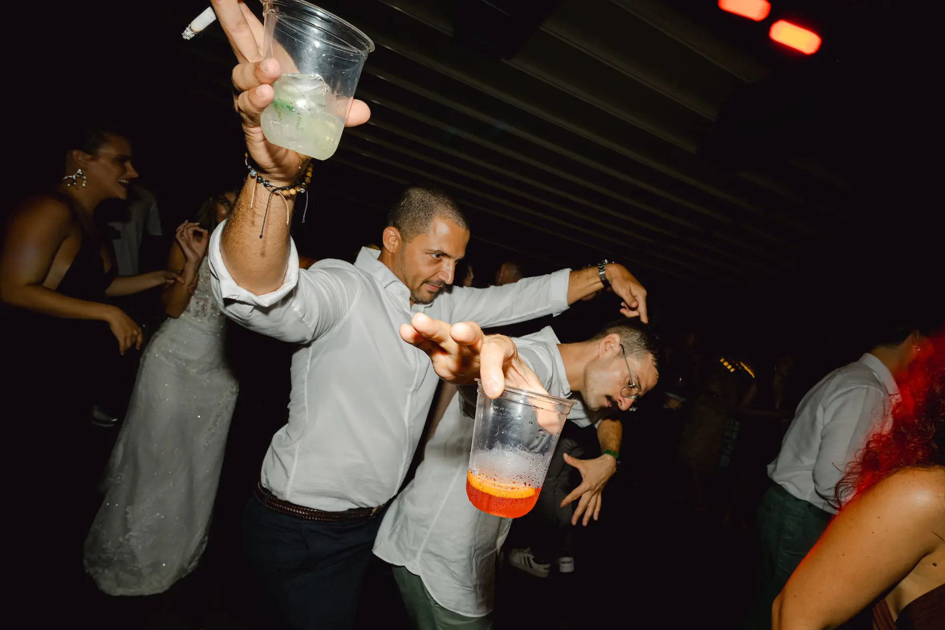 High energy wedding party with guests dancing and celebrating on the dance floor