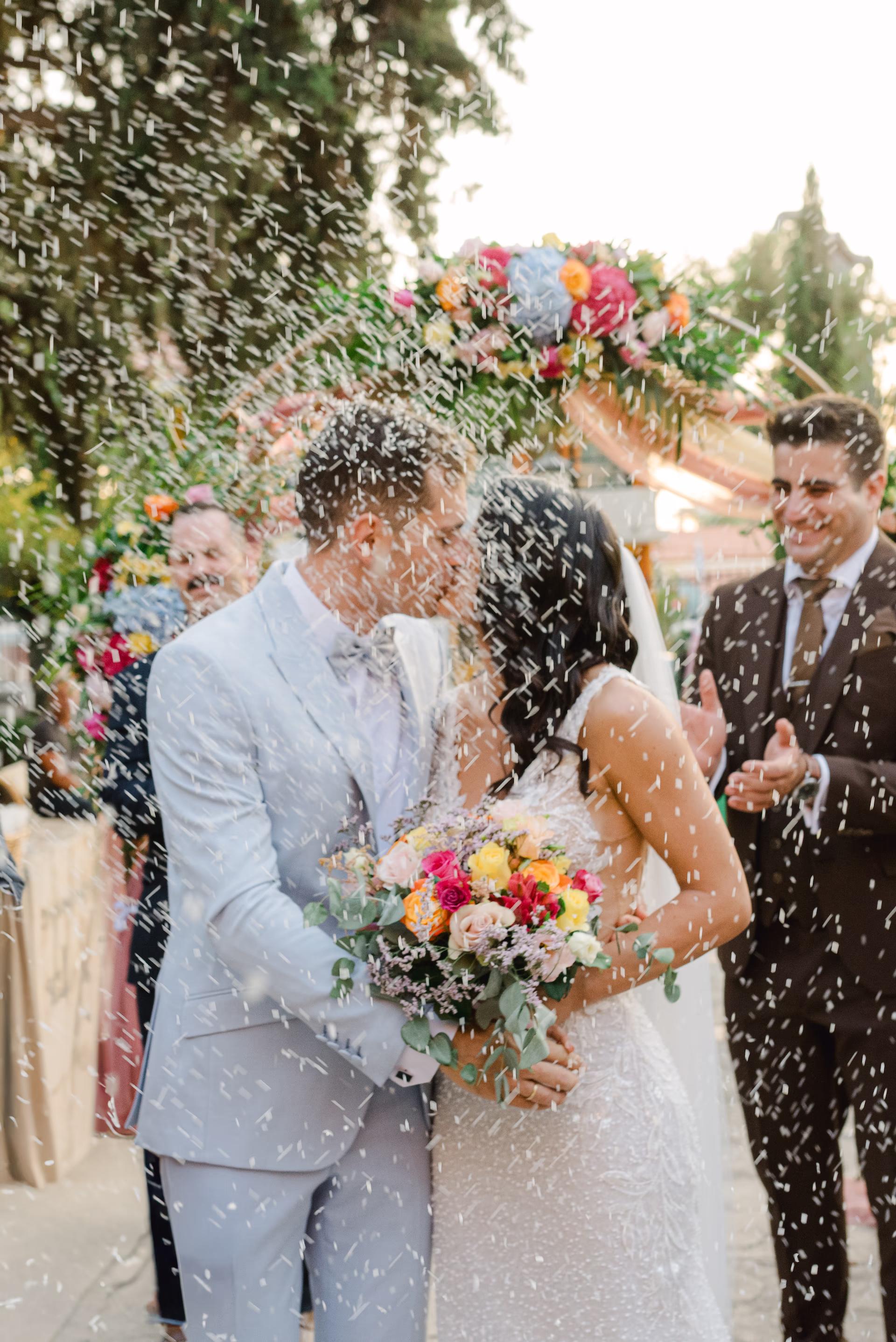 wedding couple kissing with motion blur in front of church