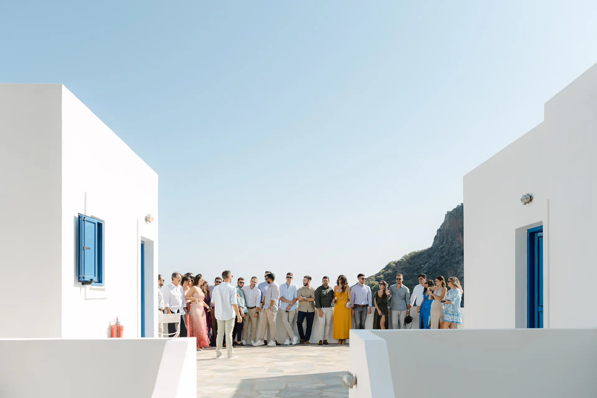 Wedding guests waiting for the first look in a traditional Cycladic-style village in Kythira, Greece.