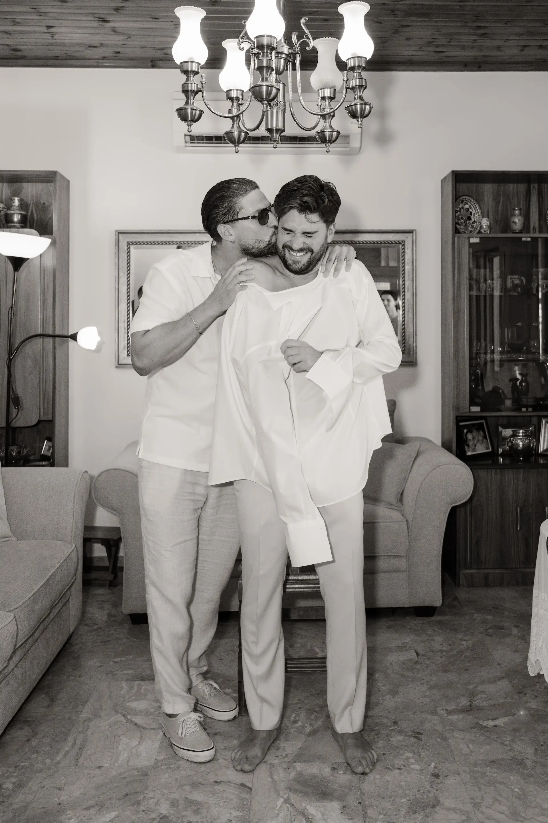 Intimate and playful moment between the groom and his best man before the ceremony