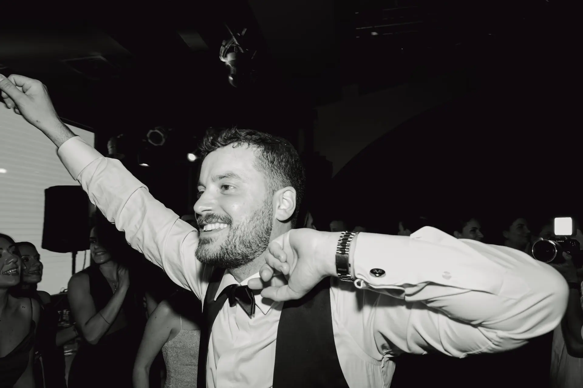 groom dancing with his arms raised
