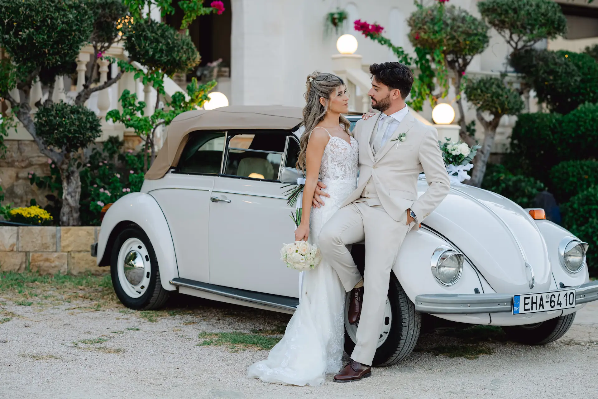 Elegant wedding photoshoot of a bride and groom with a classic vintage car