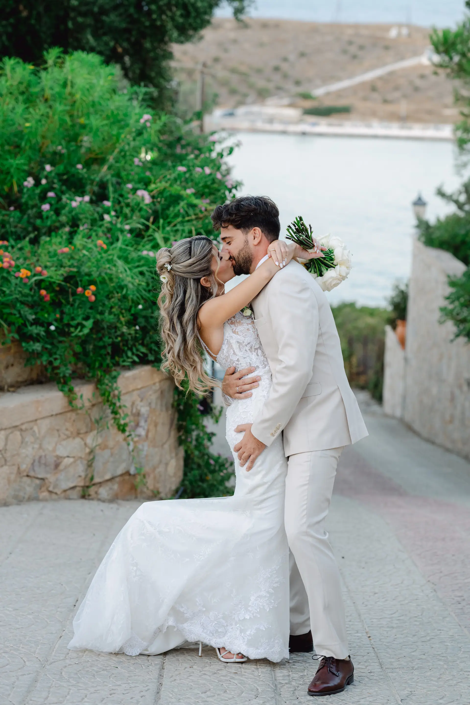 A romantic and cinematic shot of the newlyweds kissing, capturing their love and connection
