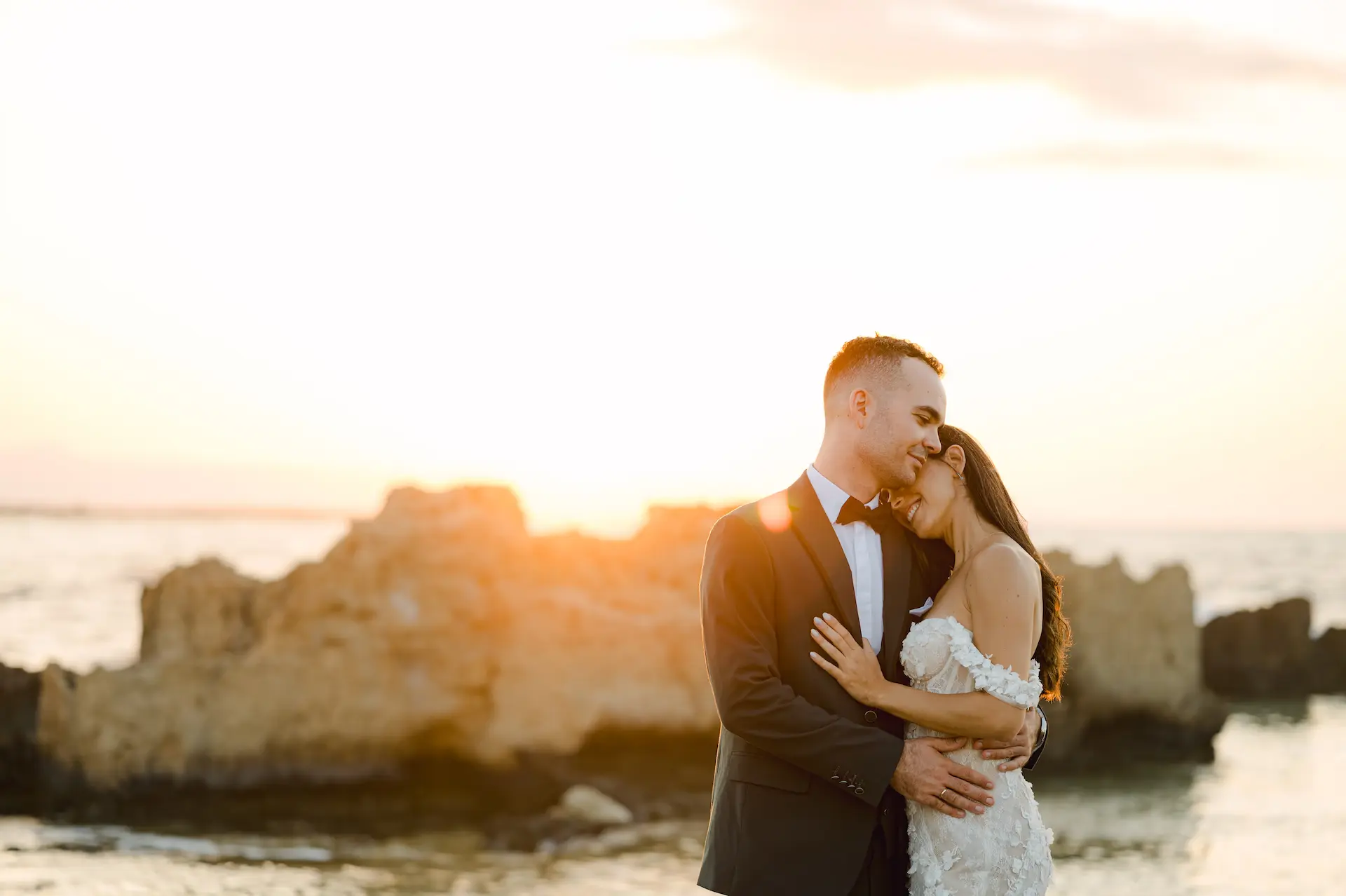 groom hugging bride during next day photoshoot at the beach