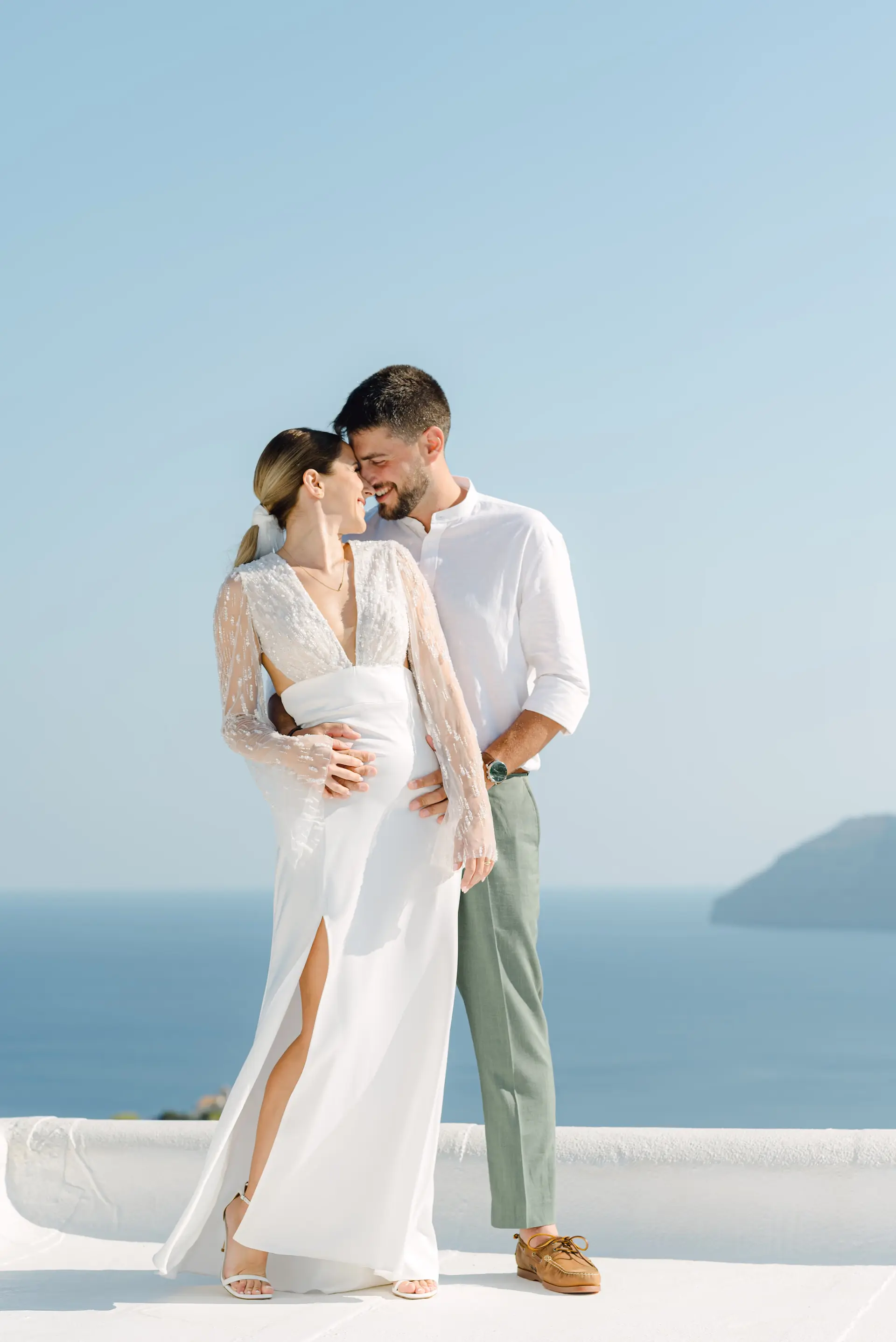 emotion portrait of bride and groom hugging with a stunning view