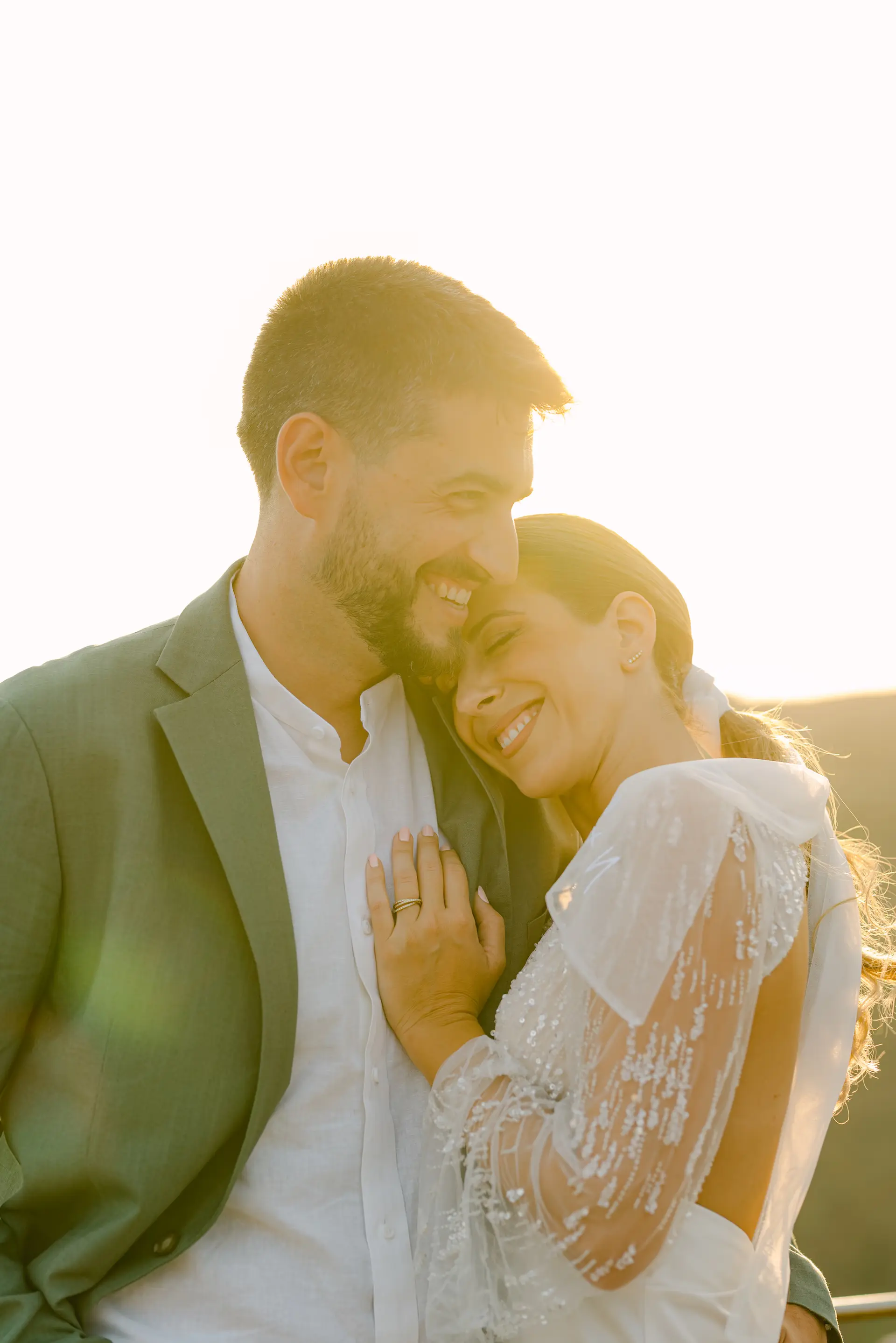 a man and woman smiling during sunset