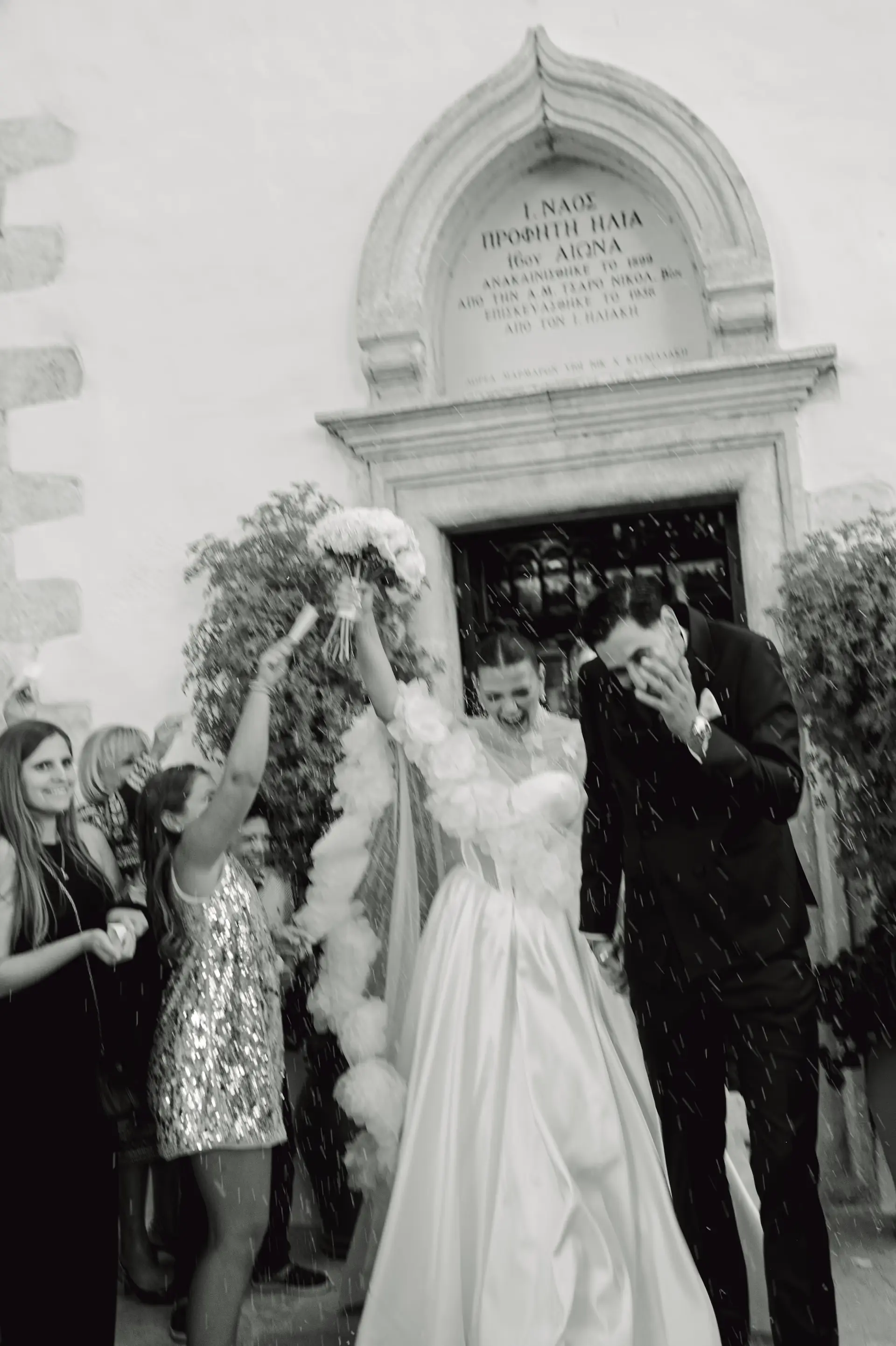 motion blurred white and black picture of the couple walking out of the church