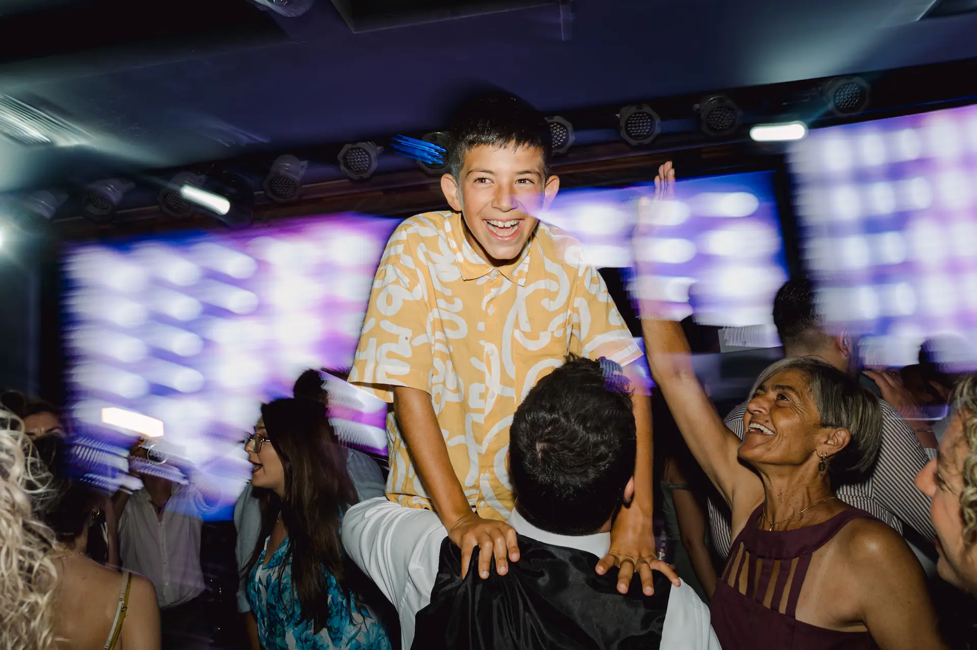 a boy sitting on a man's shoulders