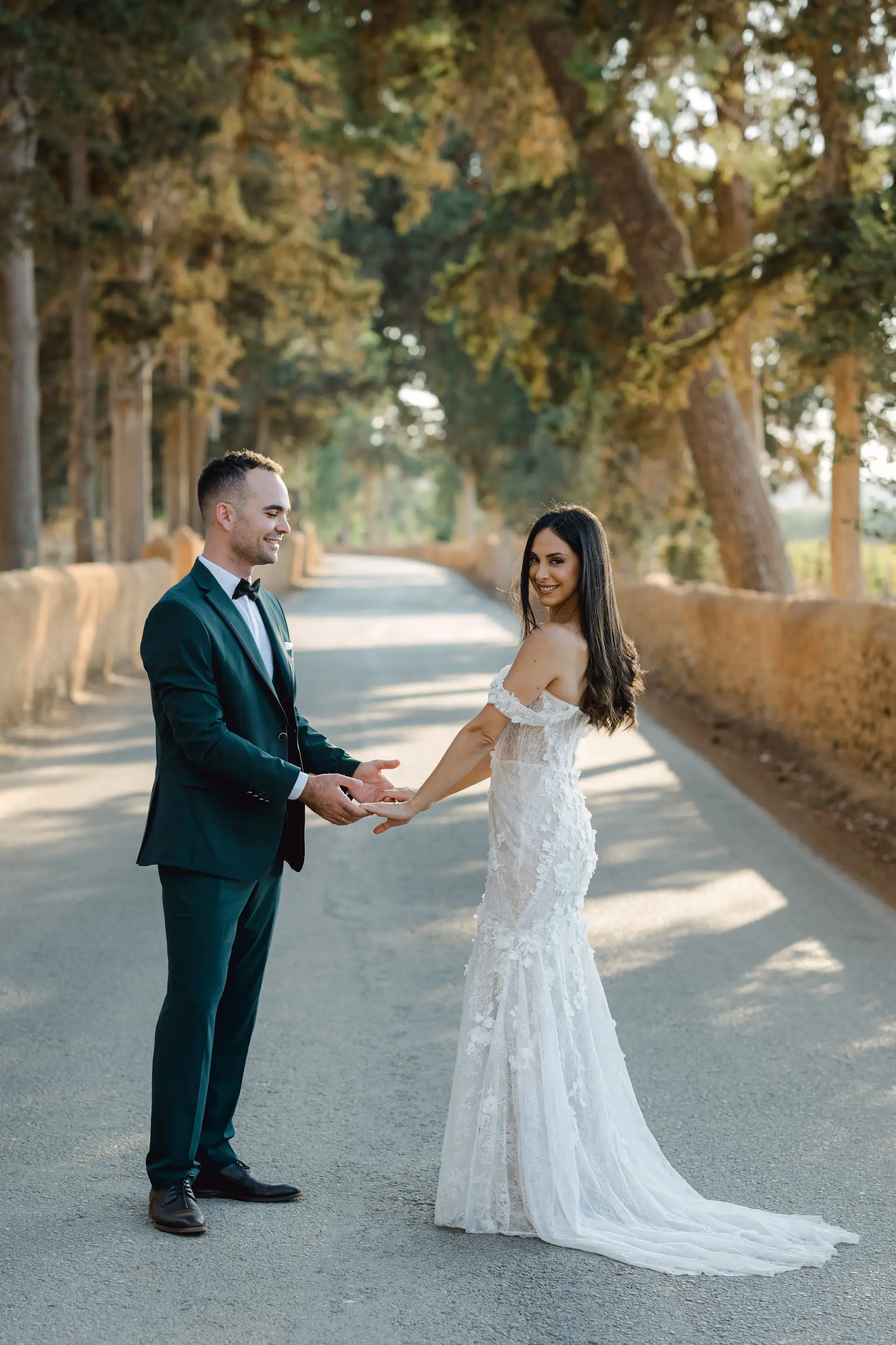 bride and groom holding hands on a road on their wedding next day photoshoot