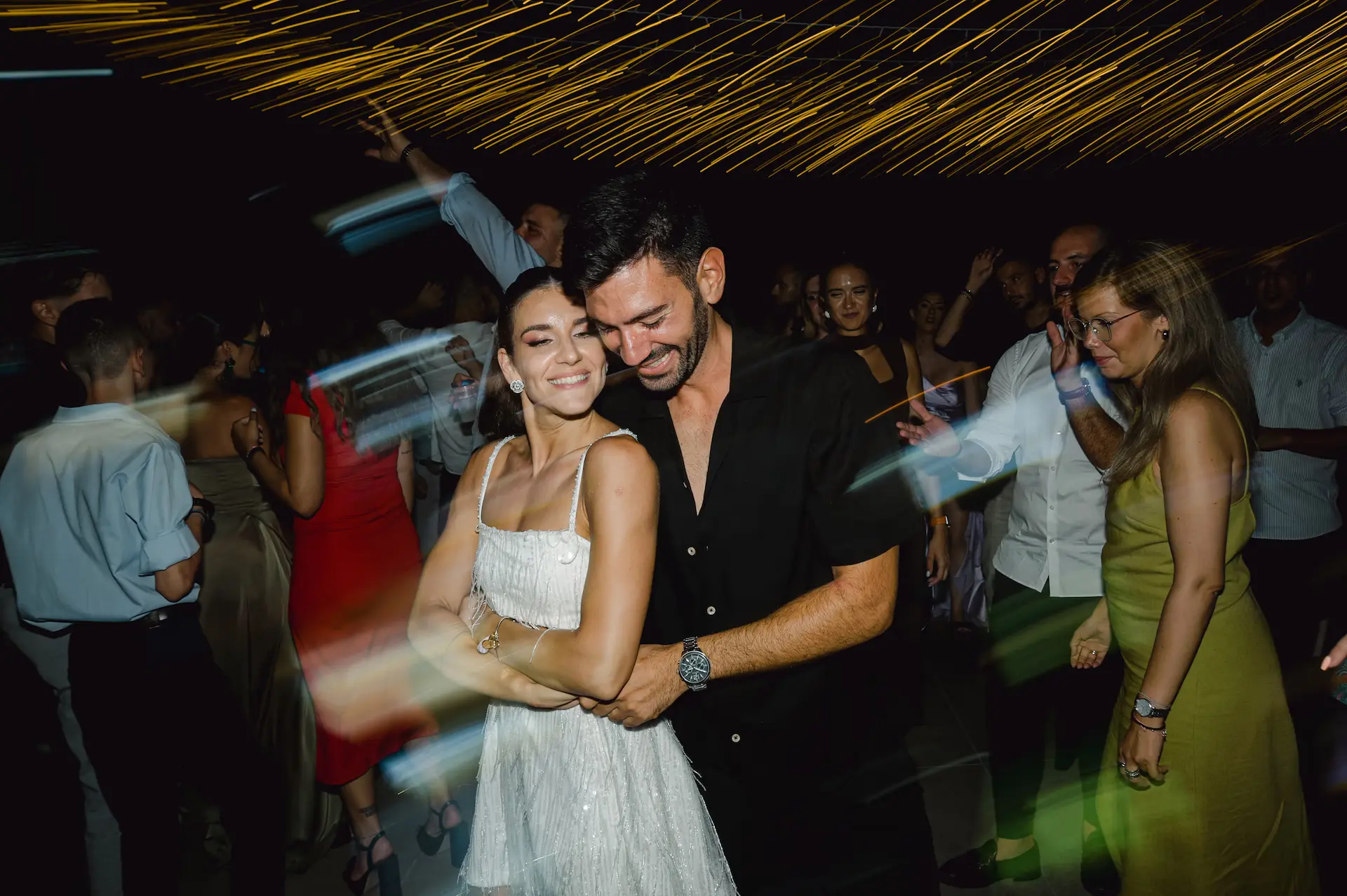 a man and woman dancing at a party