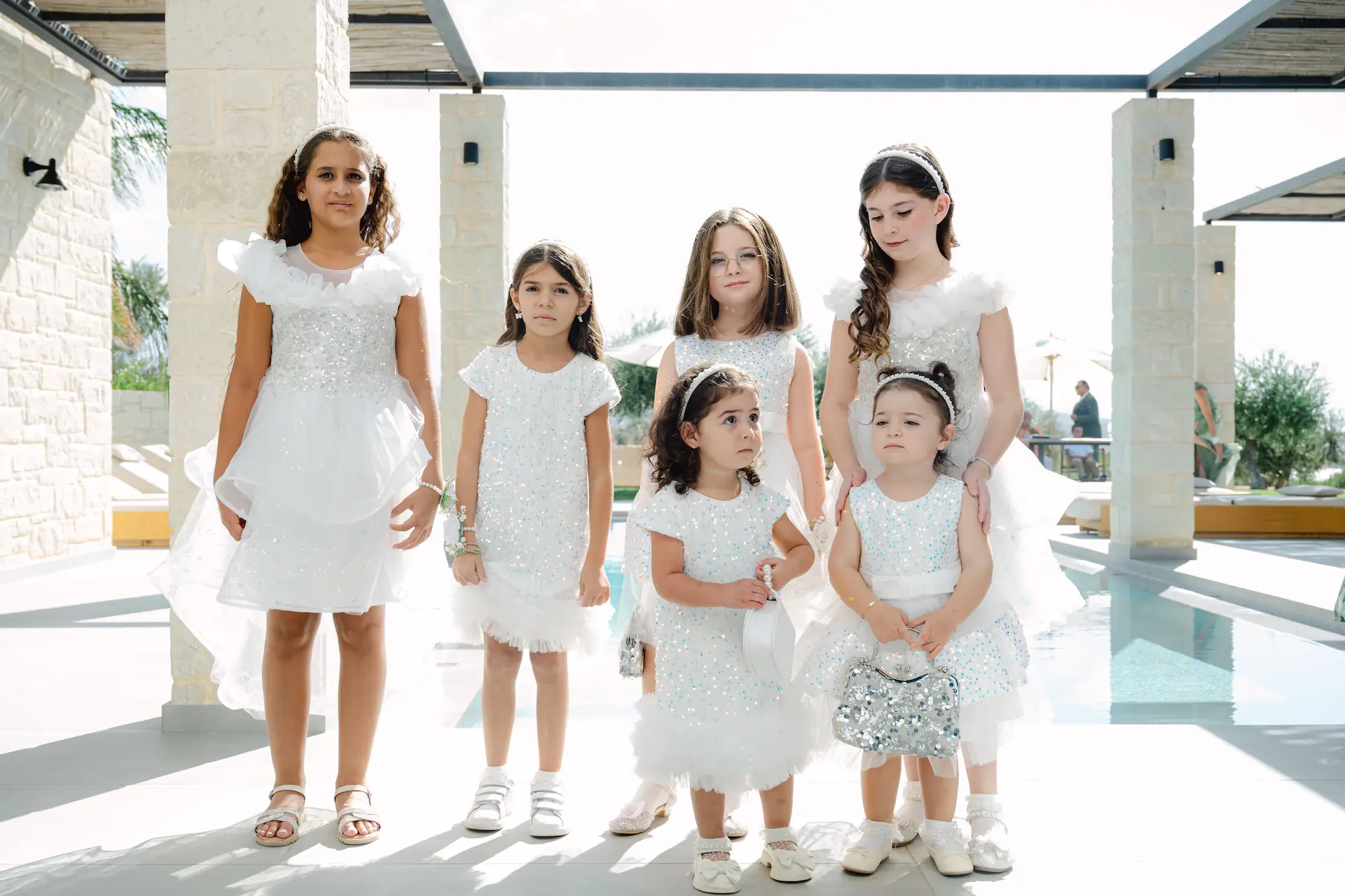 a group of girls in white dresses