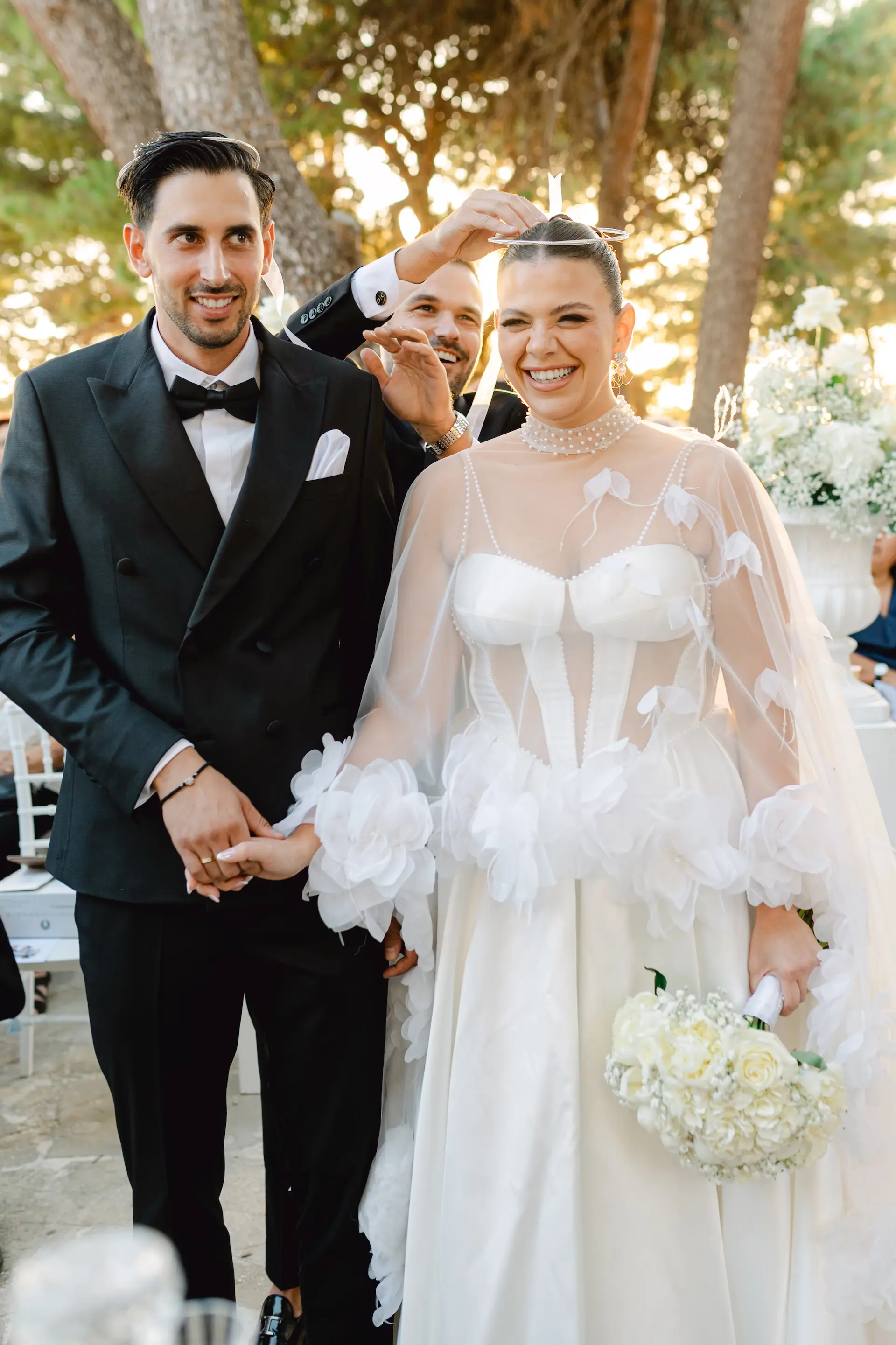 Spontaneous funny moment as the best man exchanges the wedding crowns during the ceremony in Chania