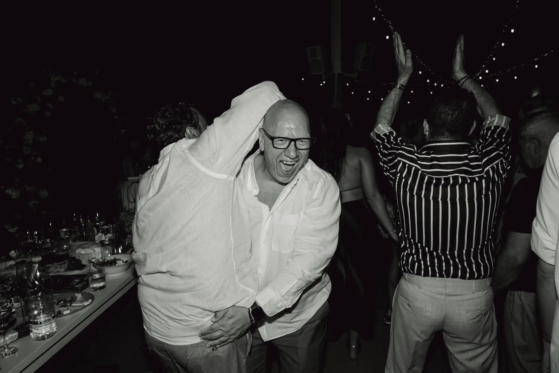 a group of people dancing in the dancefloor, black and white