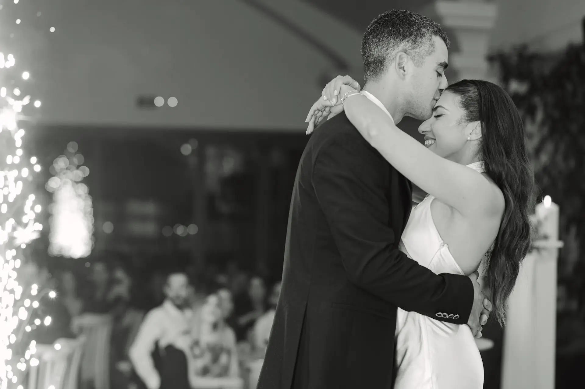 groom kissing bride's forehead during their first dance