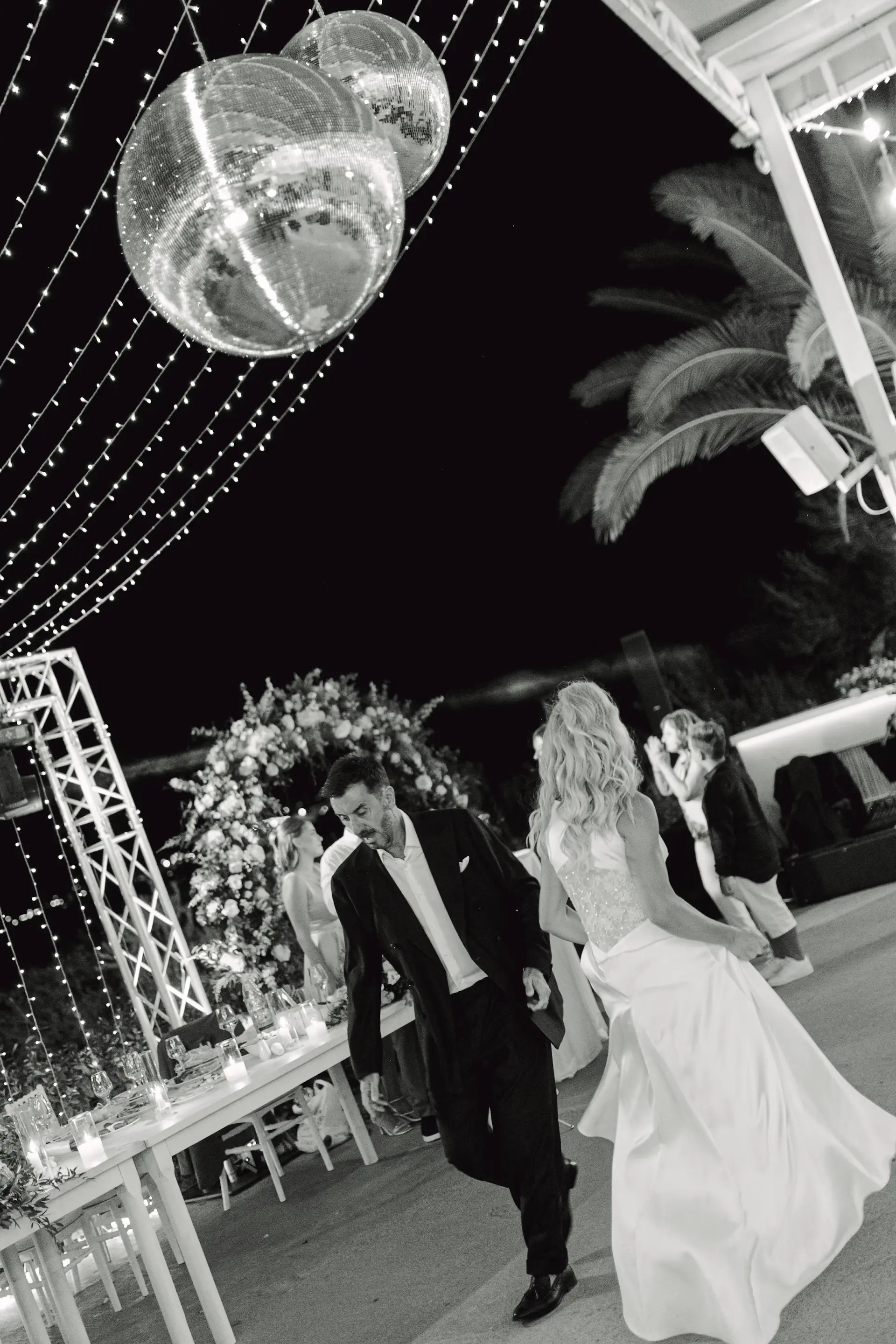 artistic black and white photo of the couple during their disco themed first dance