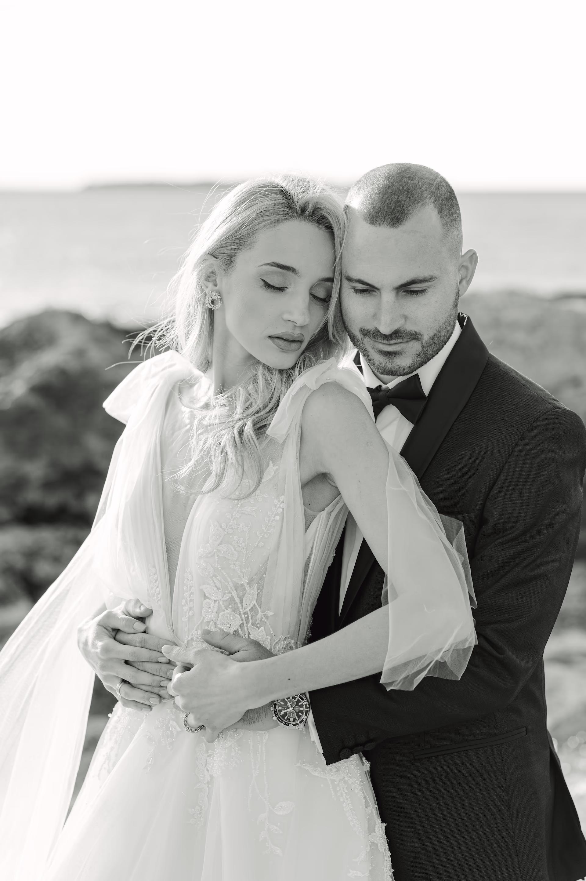 Elegant black and white editorial portrait of the bride and groom looking sophisticated.