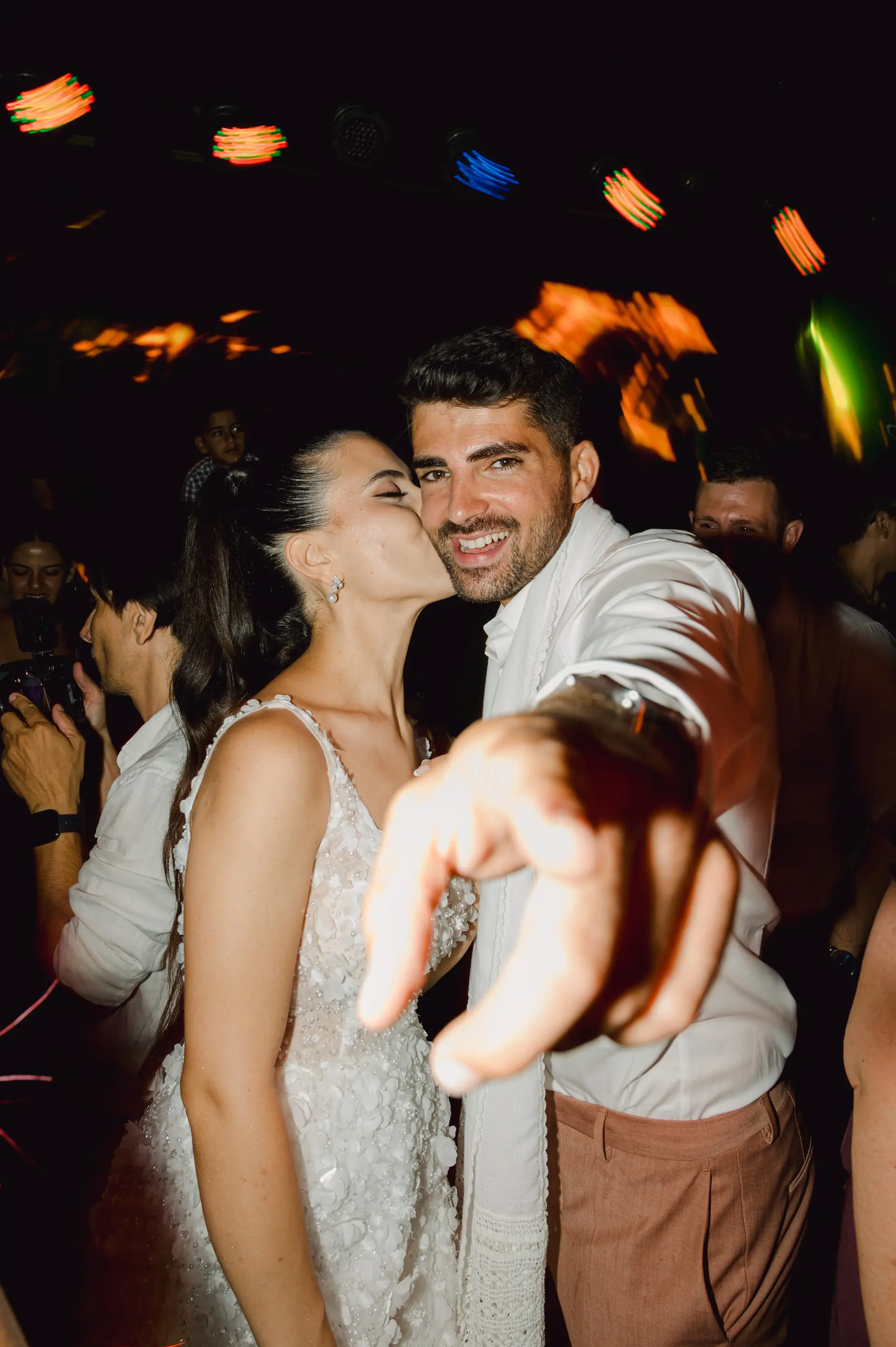 a man and woman kissing at the party