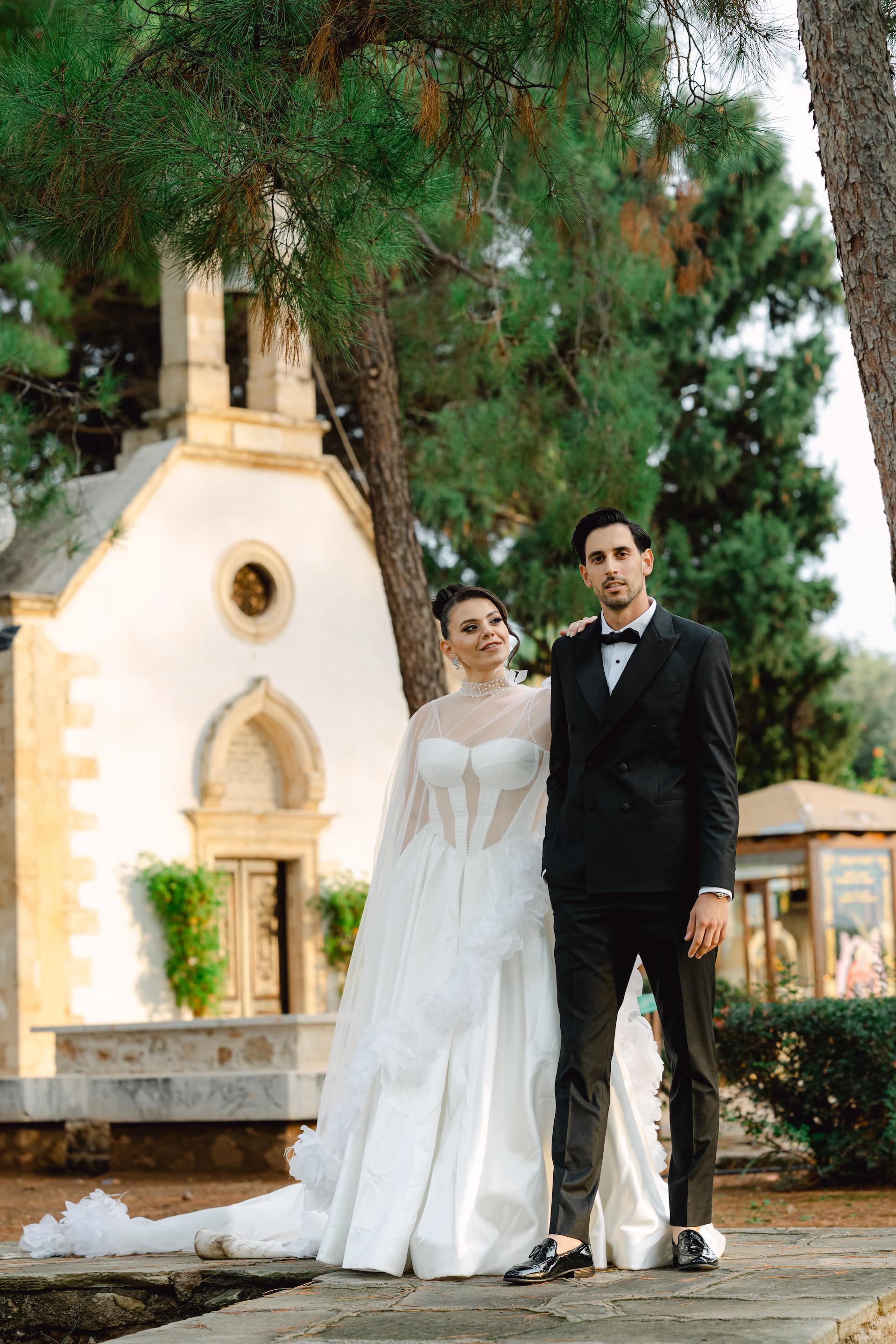 bride and groom editorial portrait in front of church in Tafous Venizelon, Akritiri