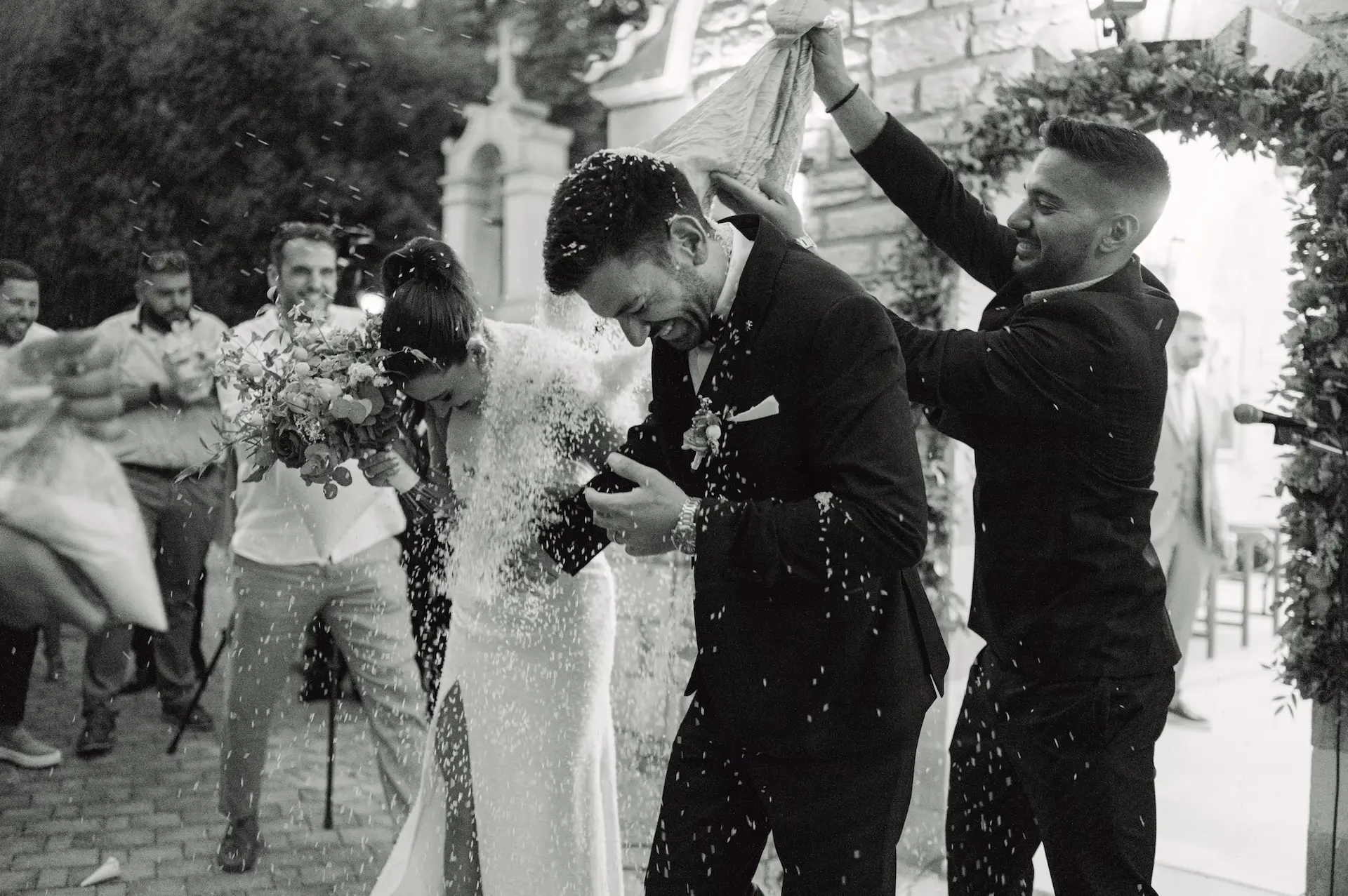 a man in a suit throwing a woman in a white dress