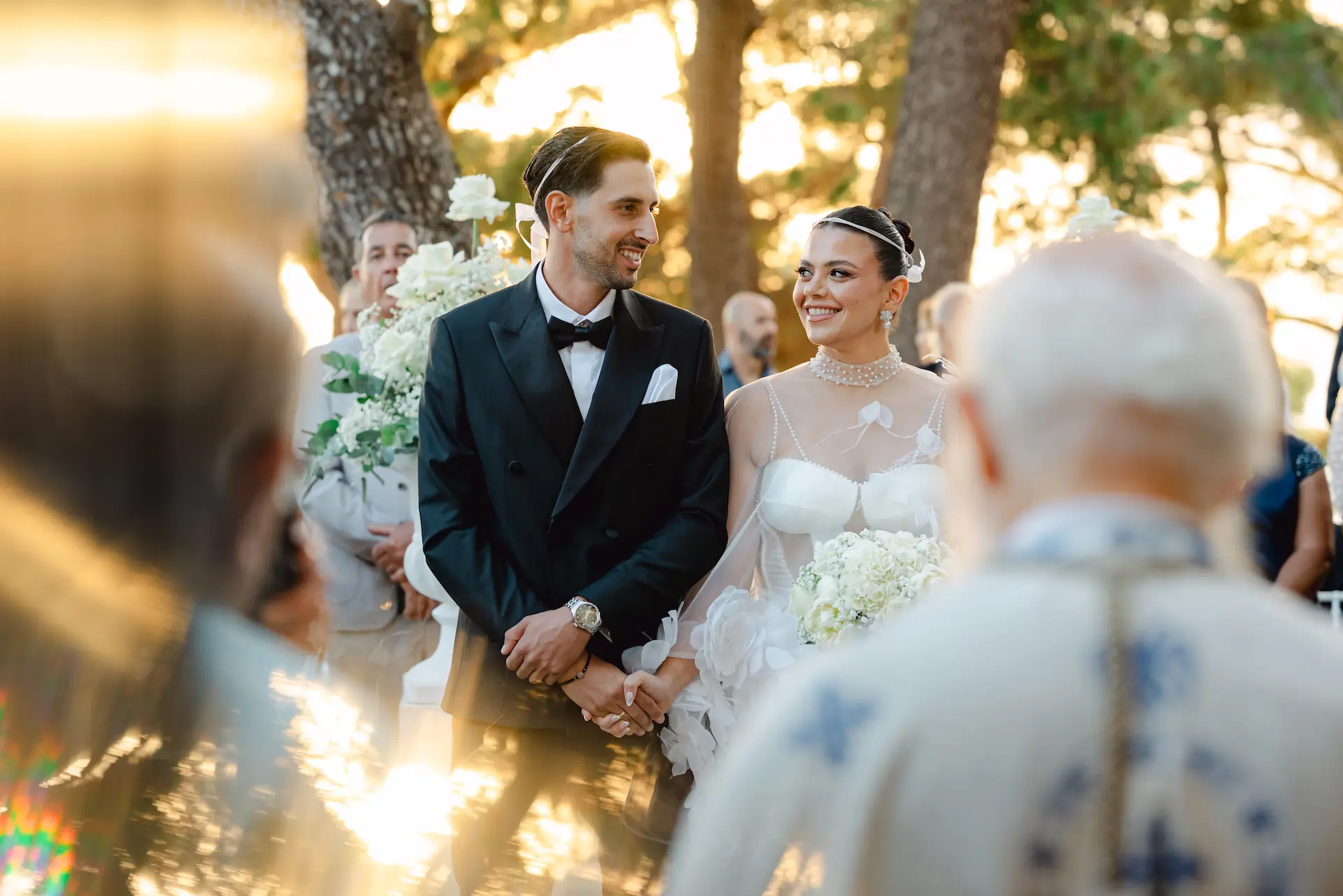Romantic glance between the newlyweds during their sunset ceremony, captured in the warm glow of the golden hour