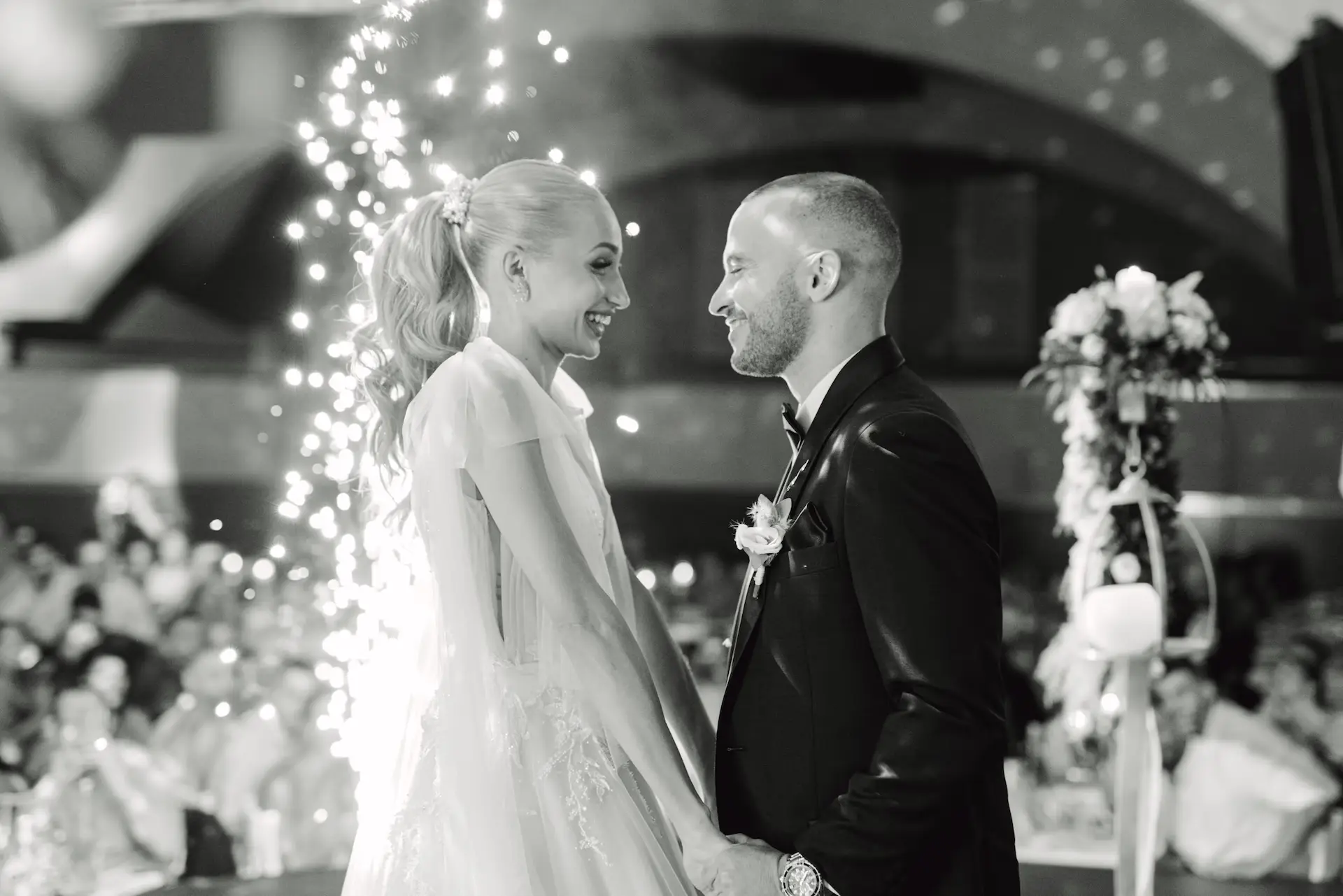 bride and groom holding hands during their first dance in Portokali hall venue