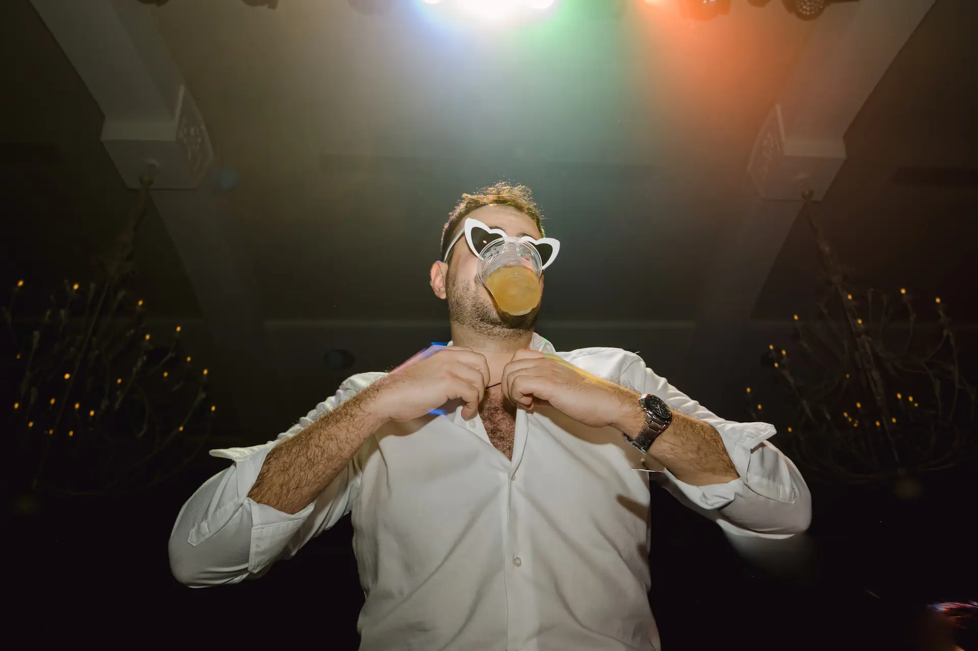 a man wearing a mask and glasses during party