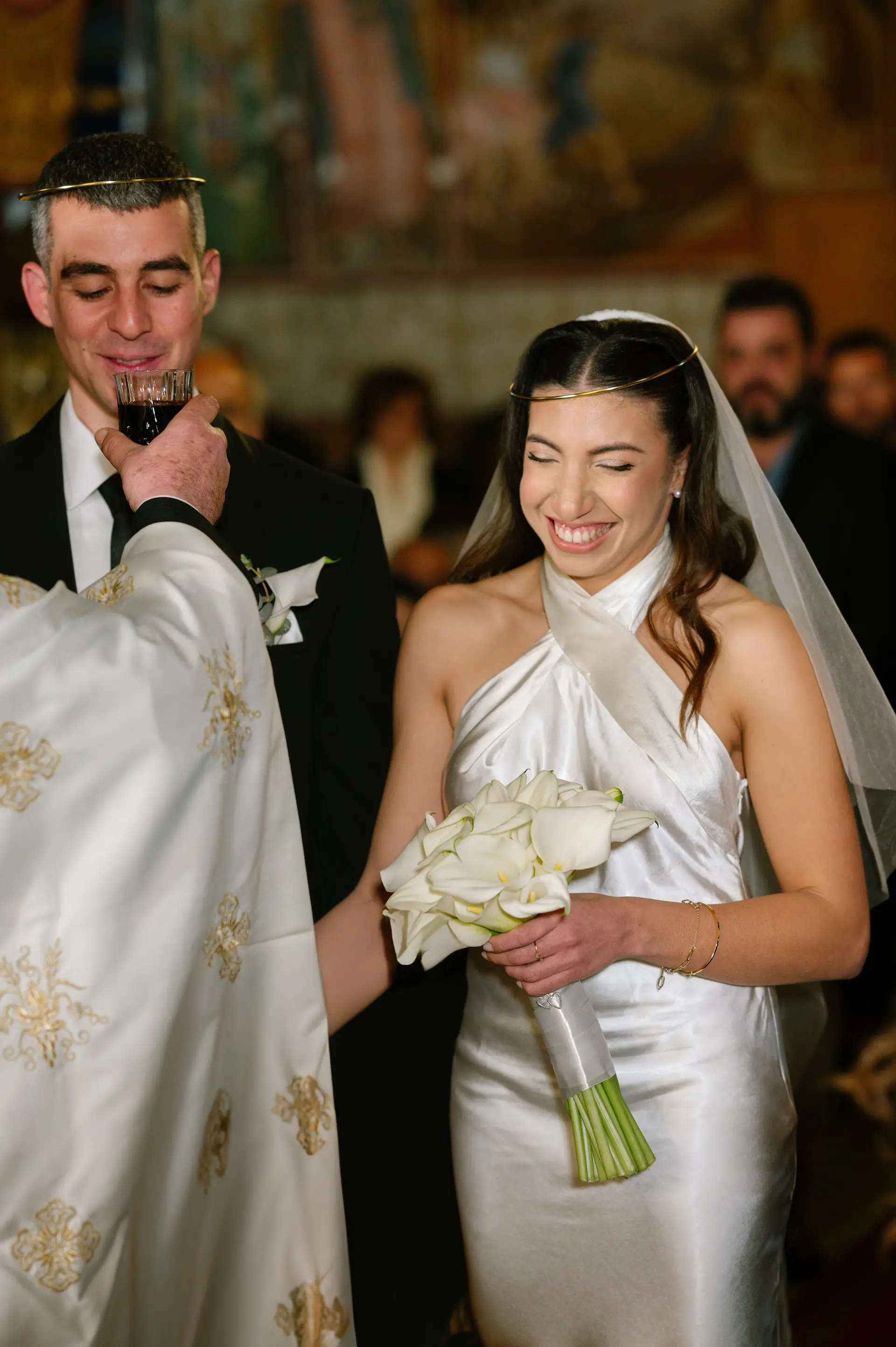 Candid wedding photography capturing a lighthearted moment of the couple laughing together during their wedding ceremony.