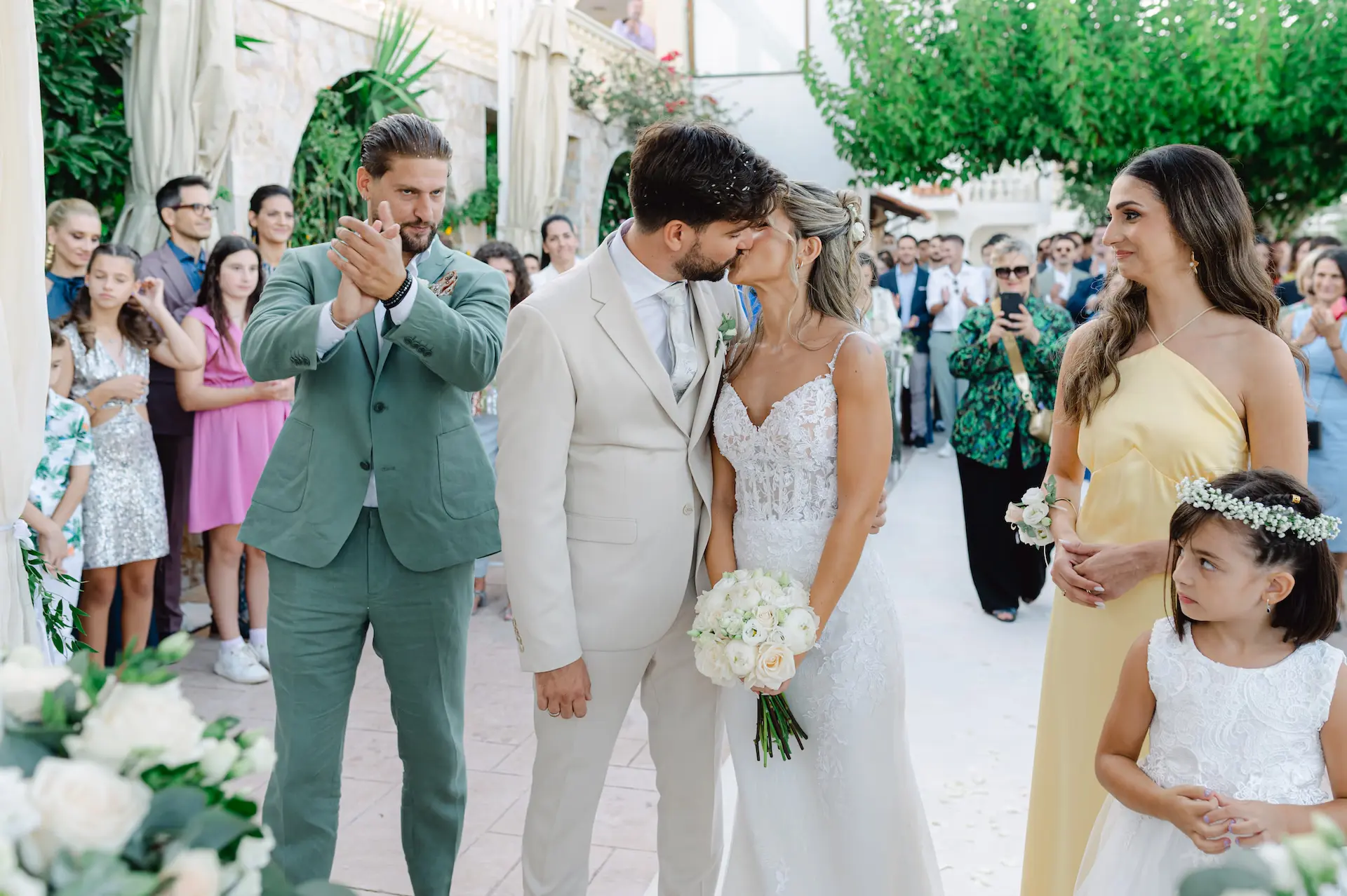 A romantic and cinematic shot of the newlyweds kissing at the altar