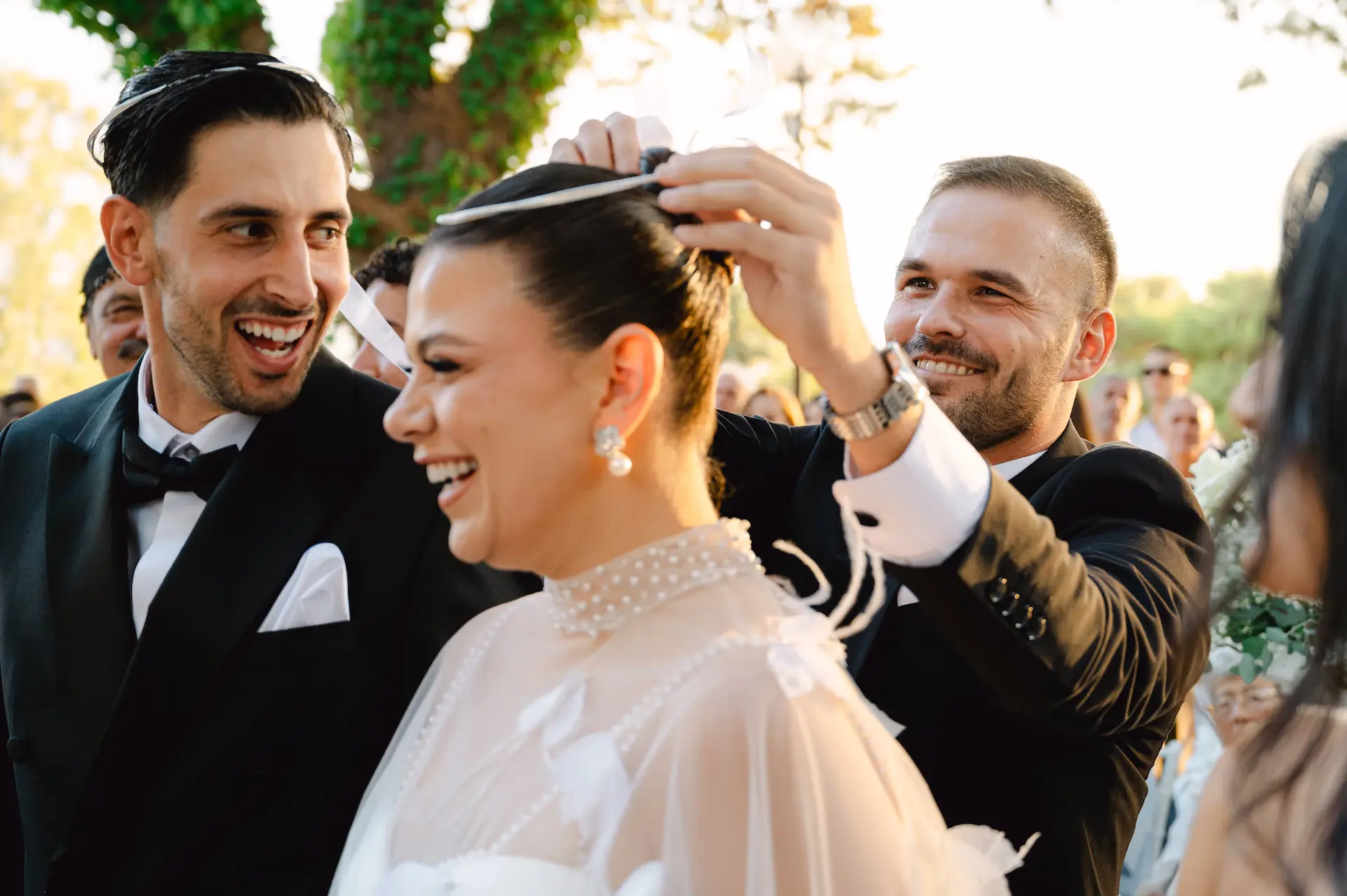best man laughing and changing the wedding crowns