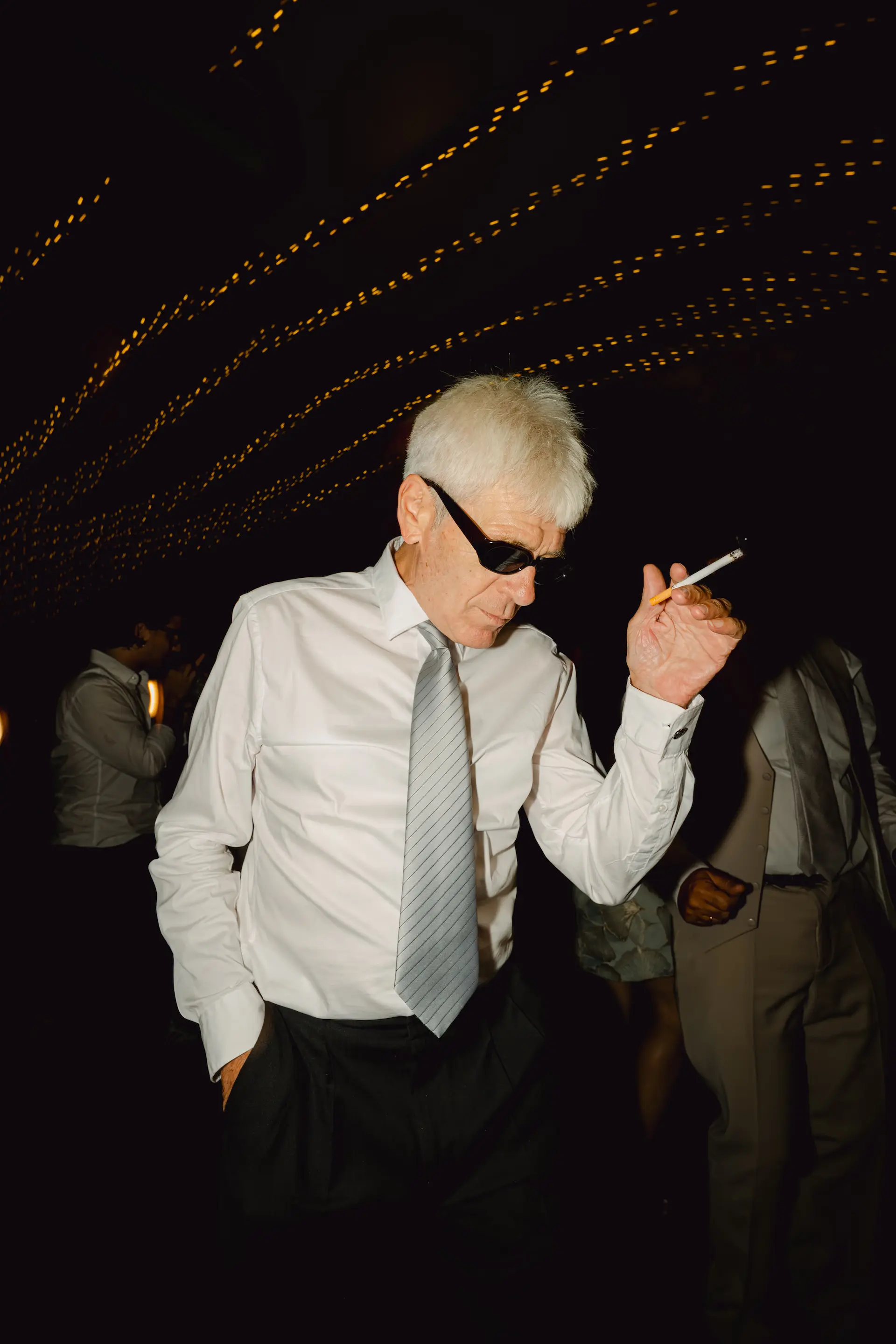 Cool senior guest dancing with sunglasses at a wedding reception, capturing a fun and energetic moment