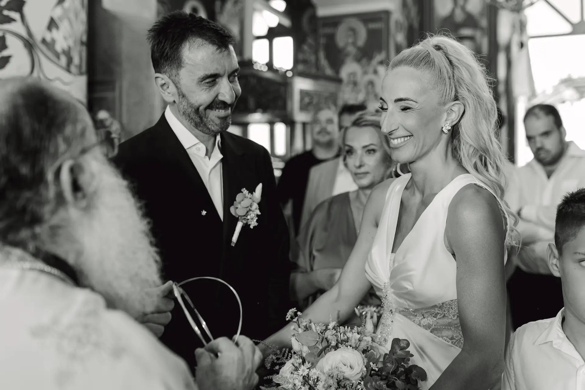 Emotional black and white wedding moment of the bride and groom sharing a genuine, joyful laugh during their celebration