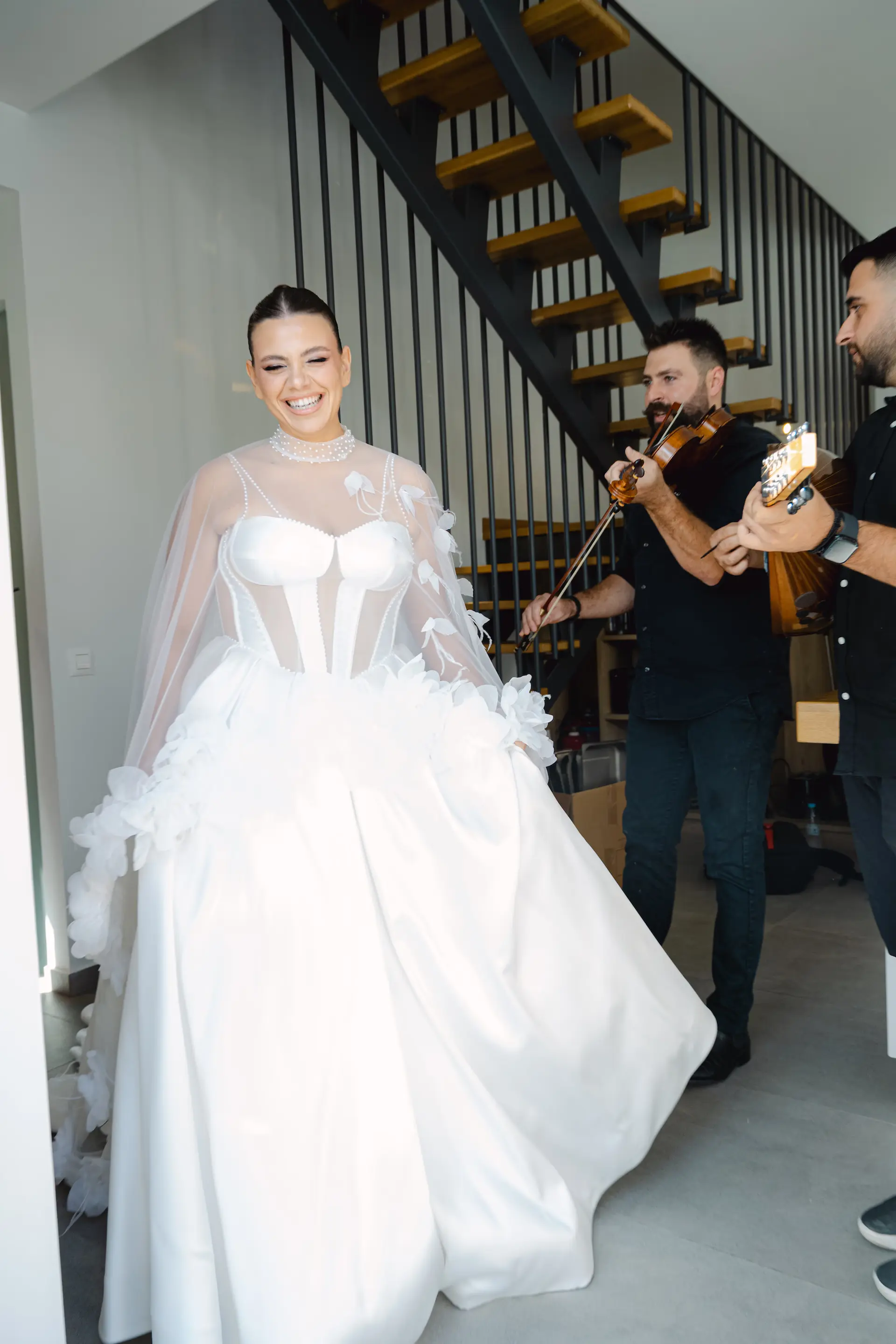 bride walking and a man playing a violin