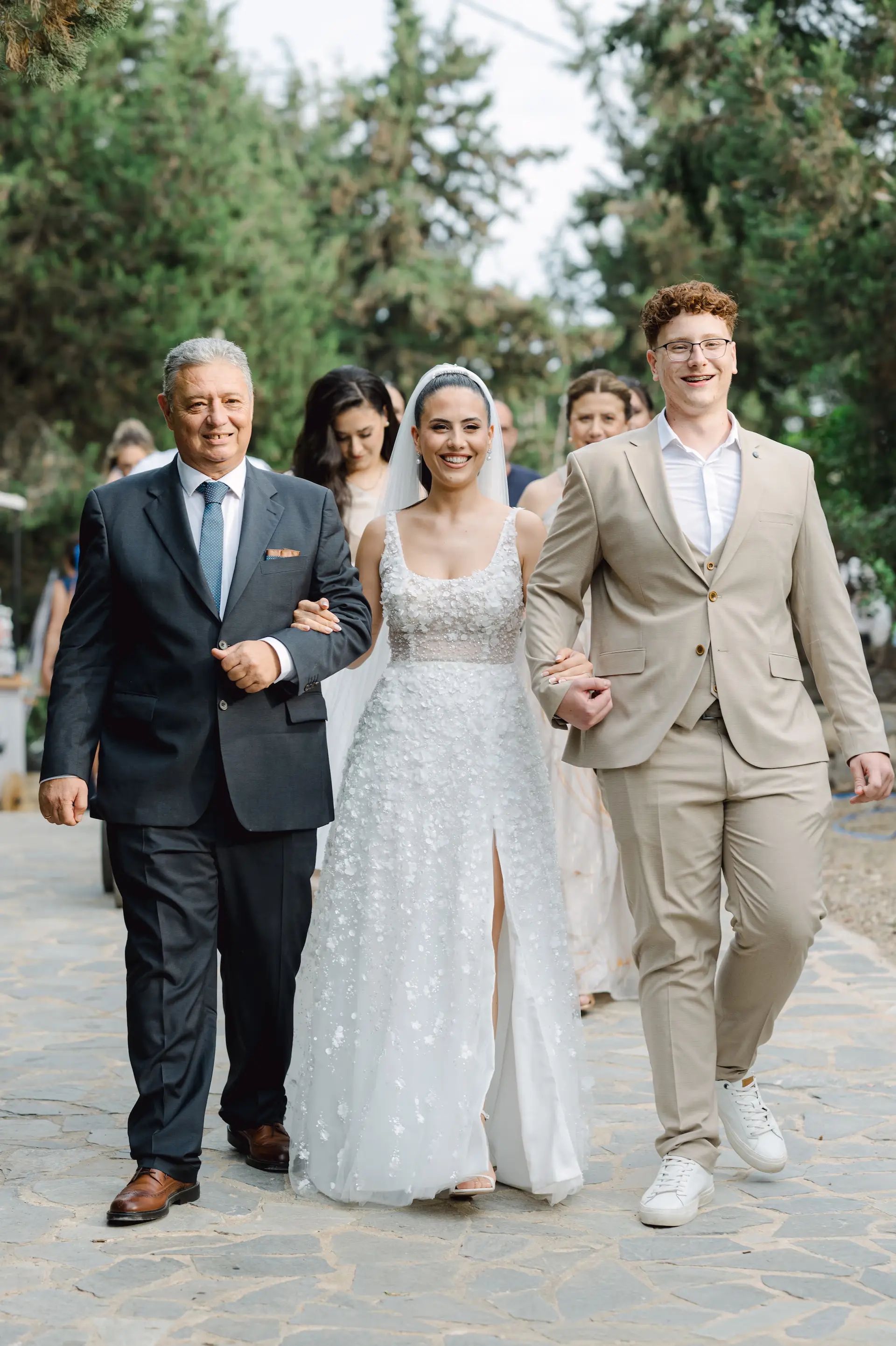 bride and her family happily walking down the aisle